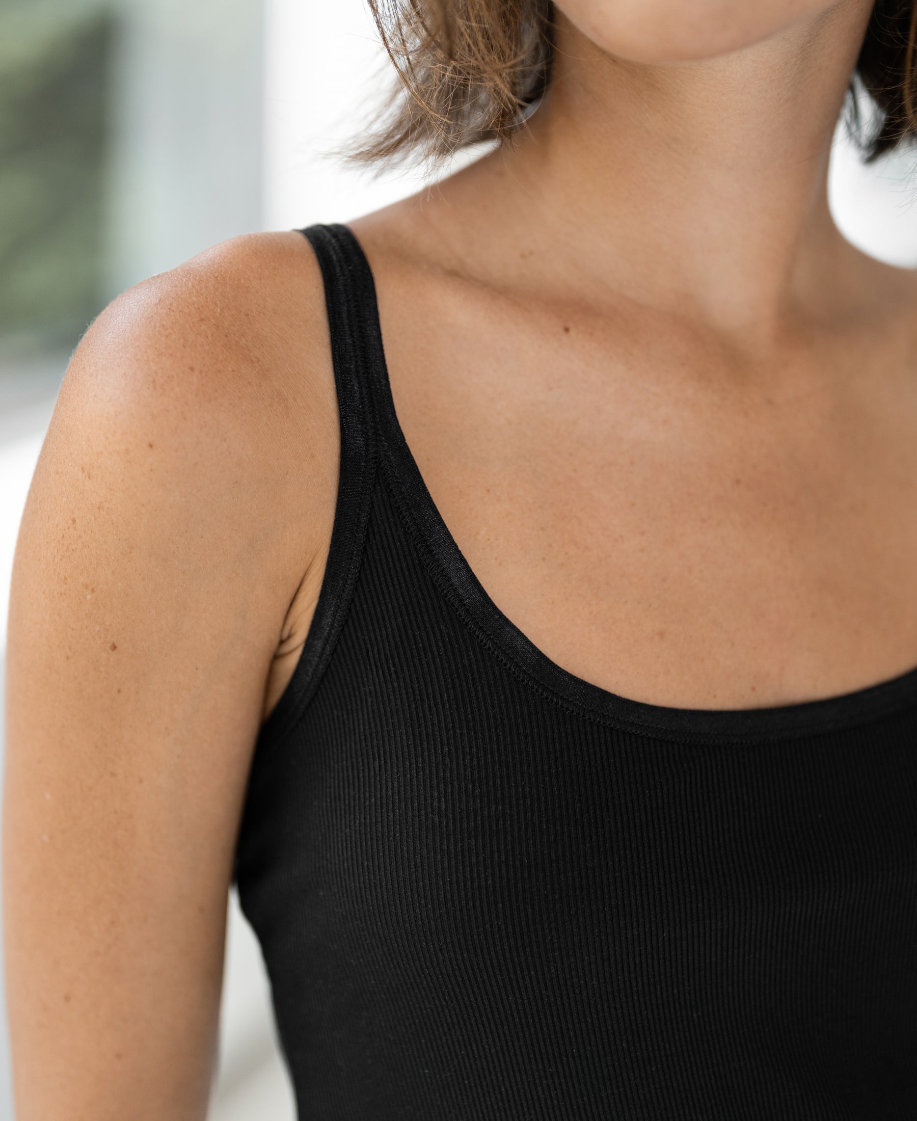 Luxe Cami top in black with satin straps by PLEIN PUBLIQUE, shown in soft indoor light.