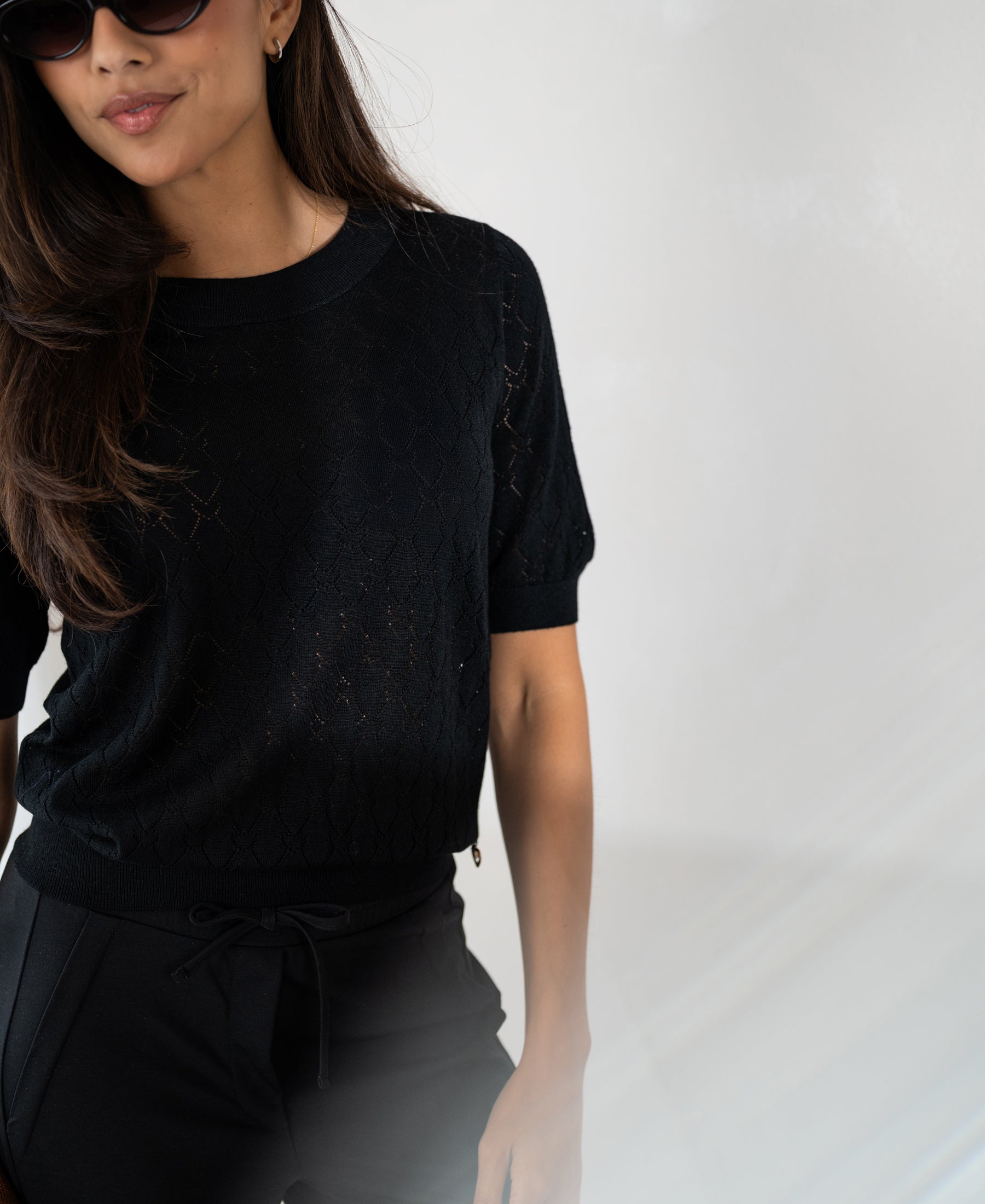 Black sweater with heart pattern by PLEIN PUBLIQUE.