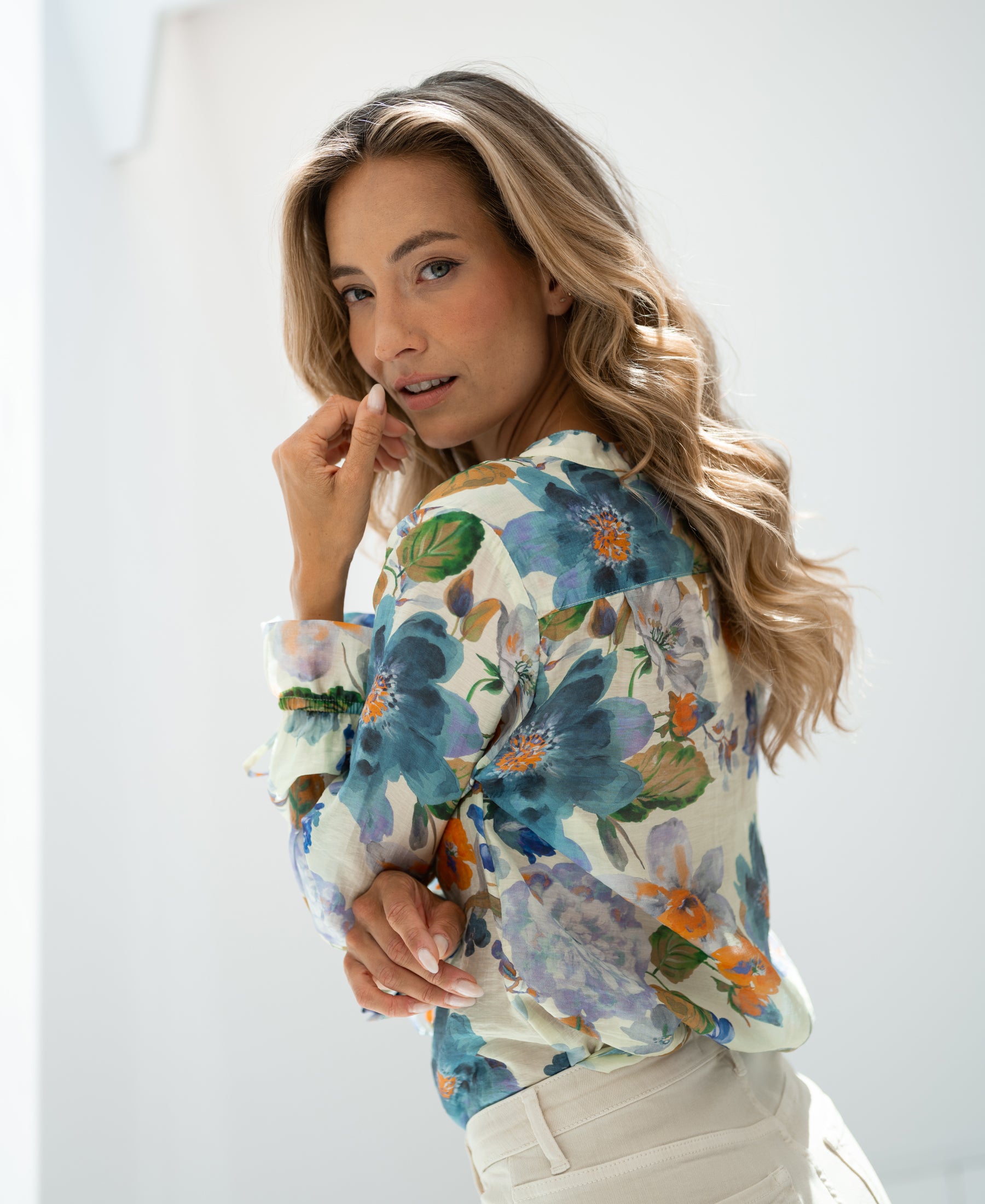 Light blue floral blouse in soft natural light.