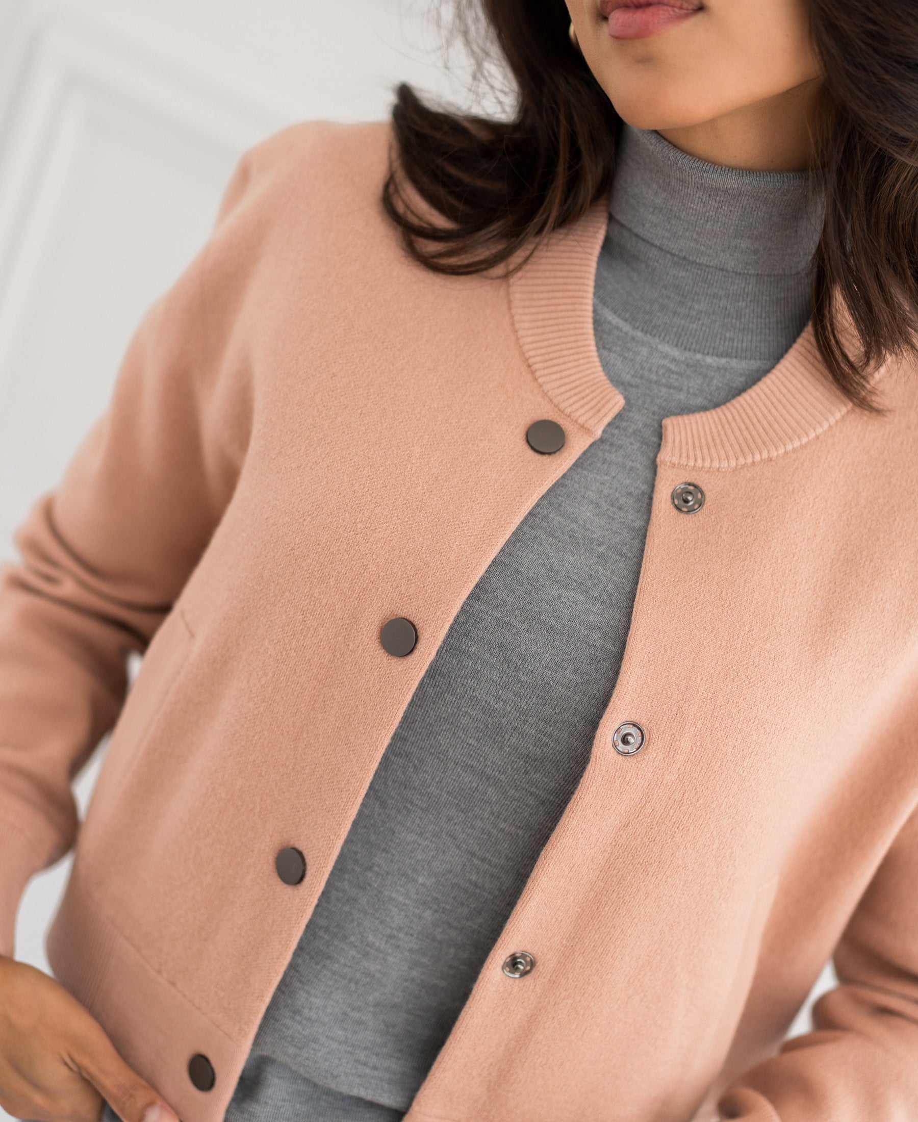 Antique blush bomber jacket LA BOMBA shown from shoulders down.