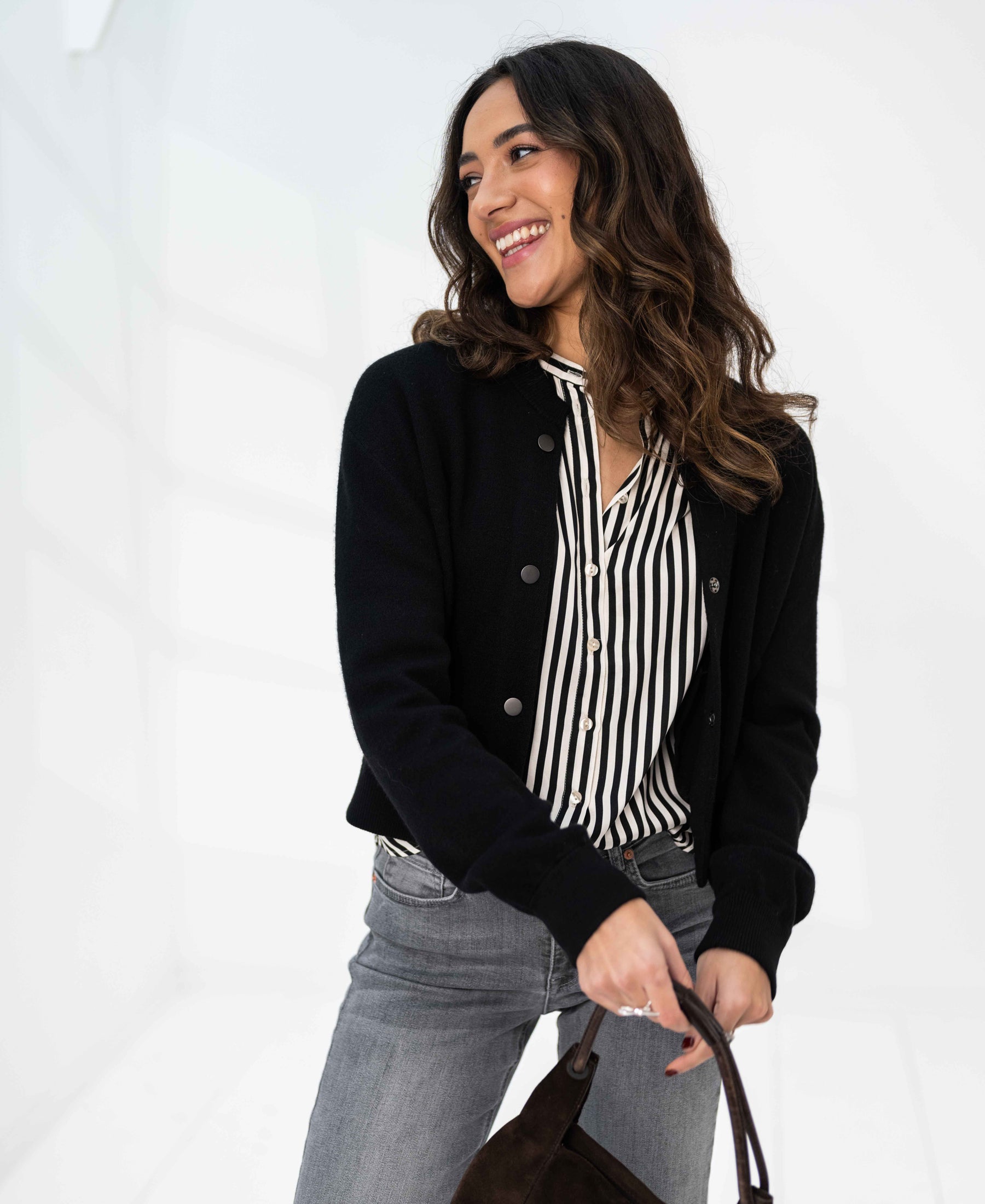 Woman in an ivory-black striped blouse by PLEIN PUBLIQUE.