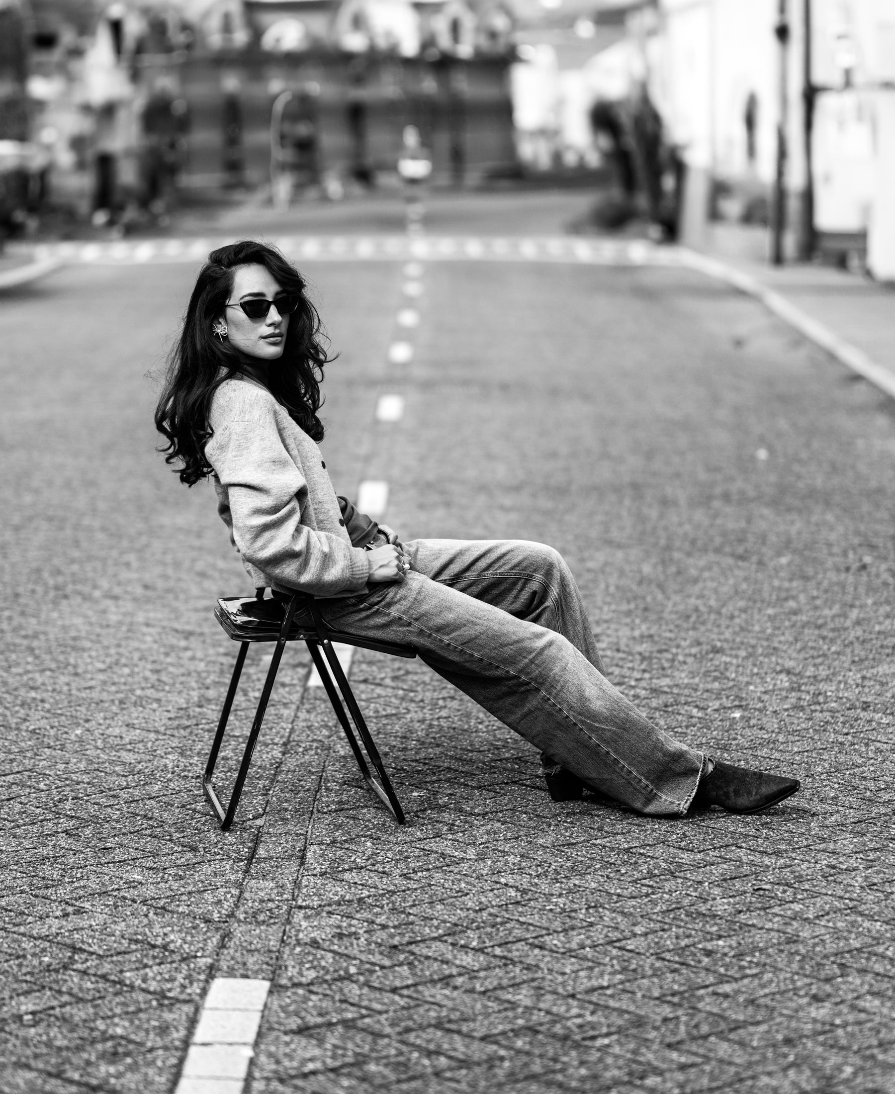 Gray mélange bomber jacket, shown from the side while seated.