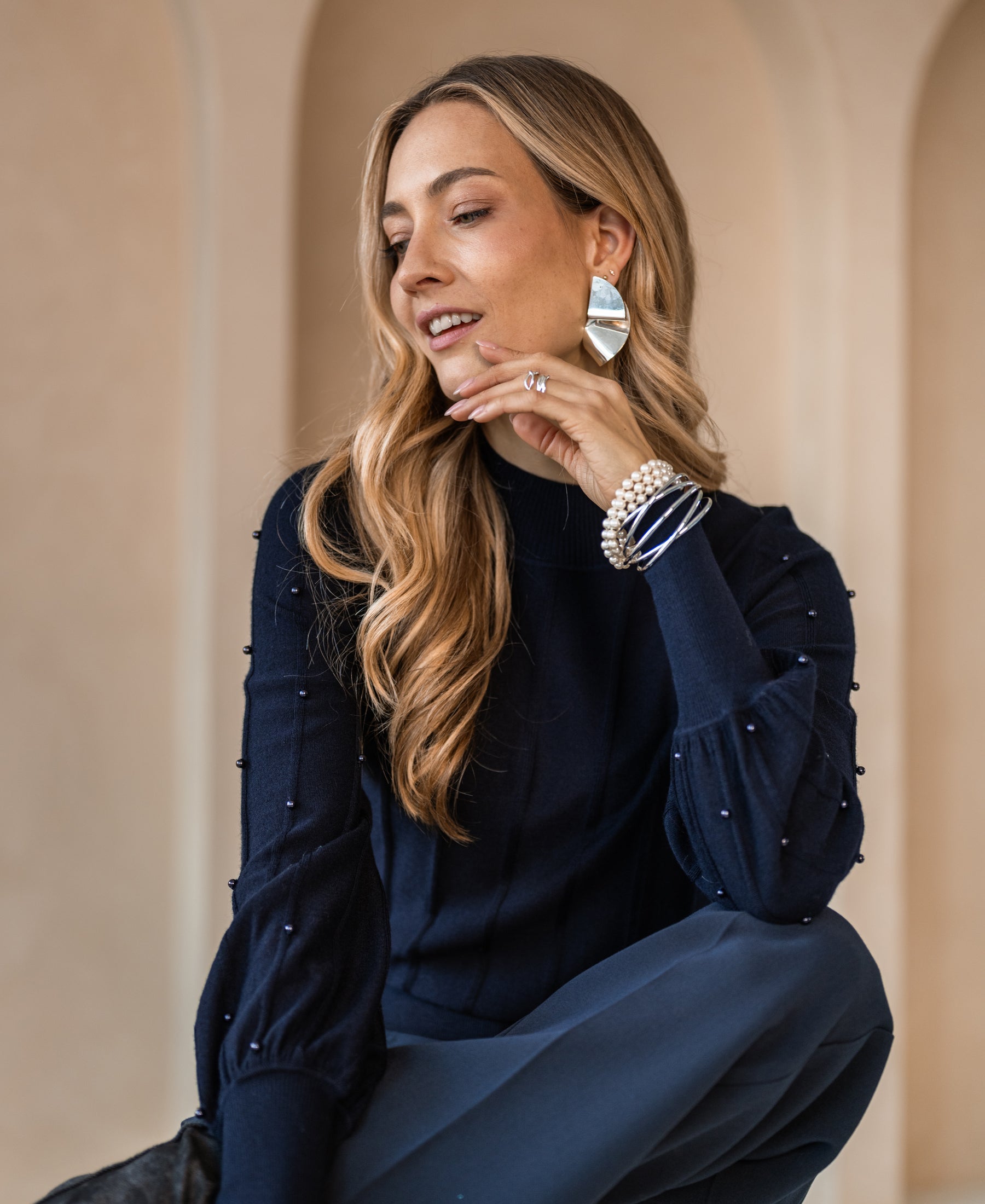 A PLEIN PUBLIQUE dark blue turtleneck sweater with beaded details.