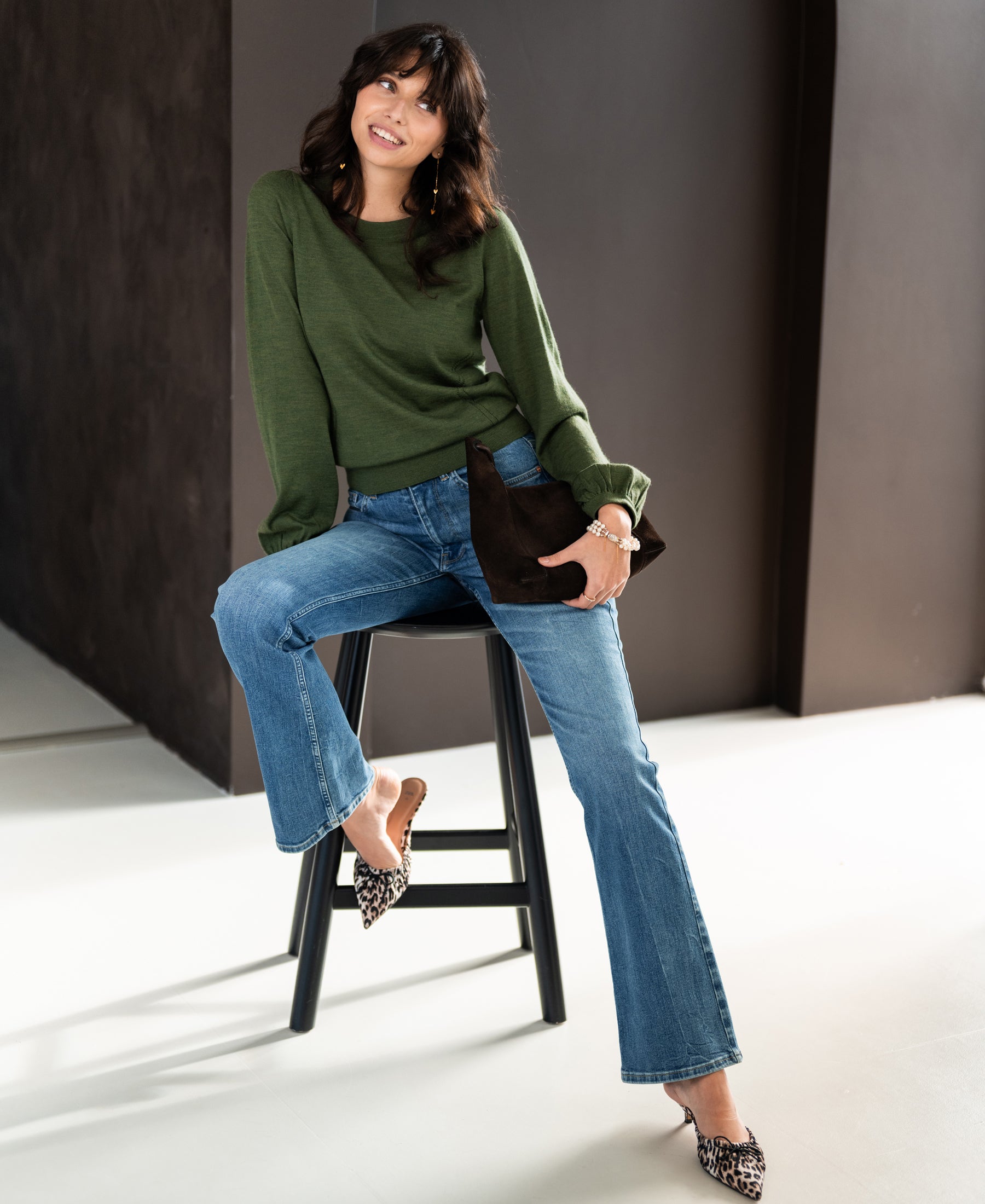 Woman wearing PLEIN PUBLIQUE LA COEUR Merino wool sweater in olive green.