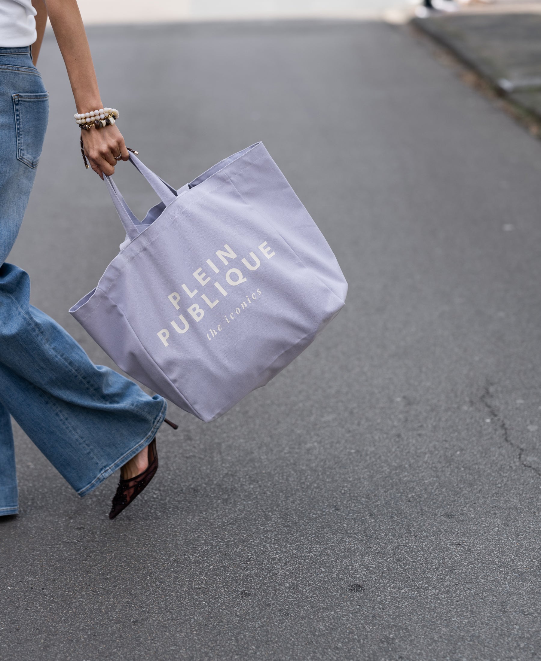 Large canvas tote bag in lilac, shown held by model.