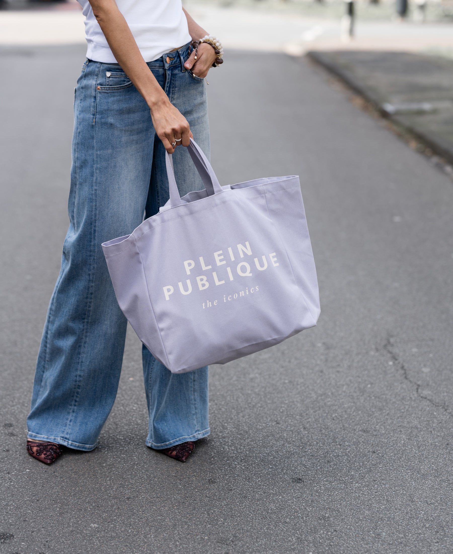 PLEIN PUBLIQUE canvas tote bag "The Lila Bag" shown being held, natural color.