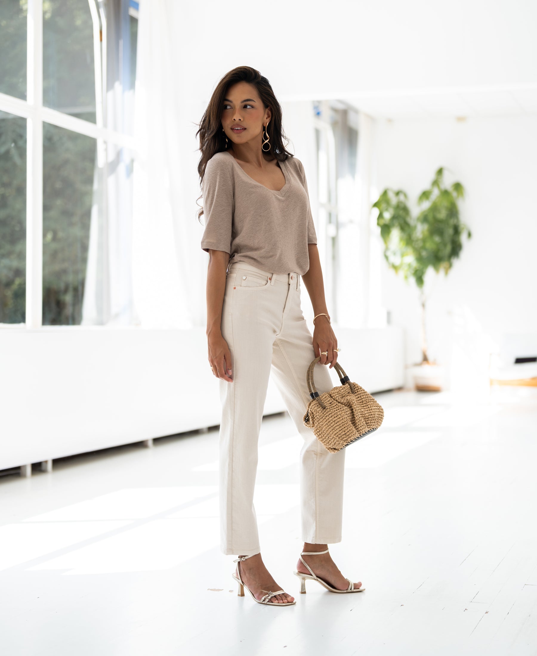 Natural linen T-shirt in a bright room.