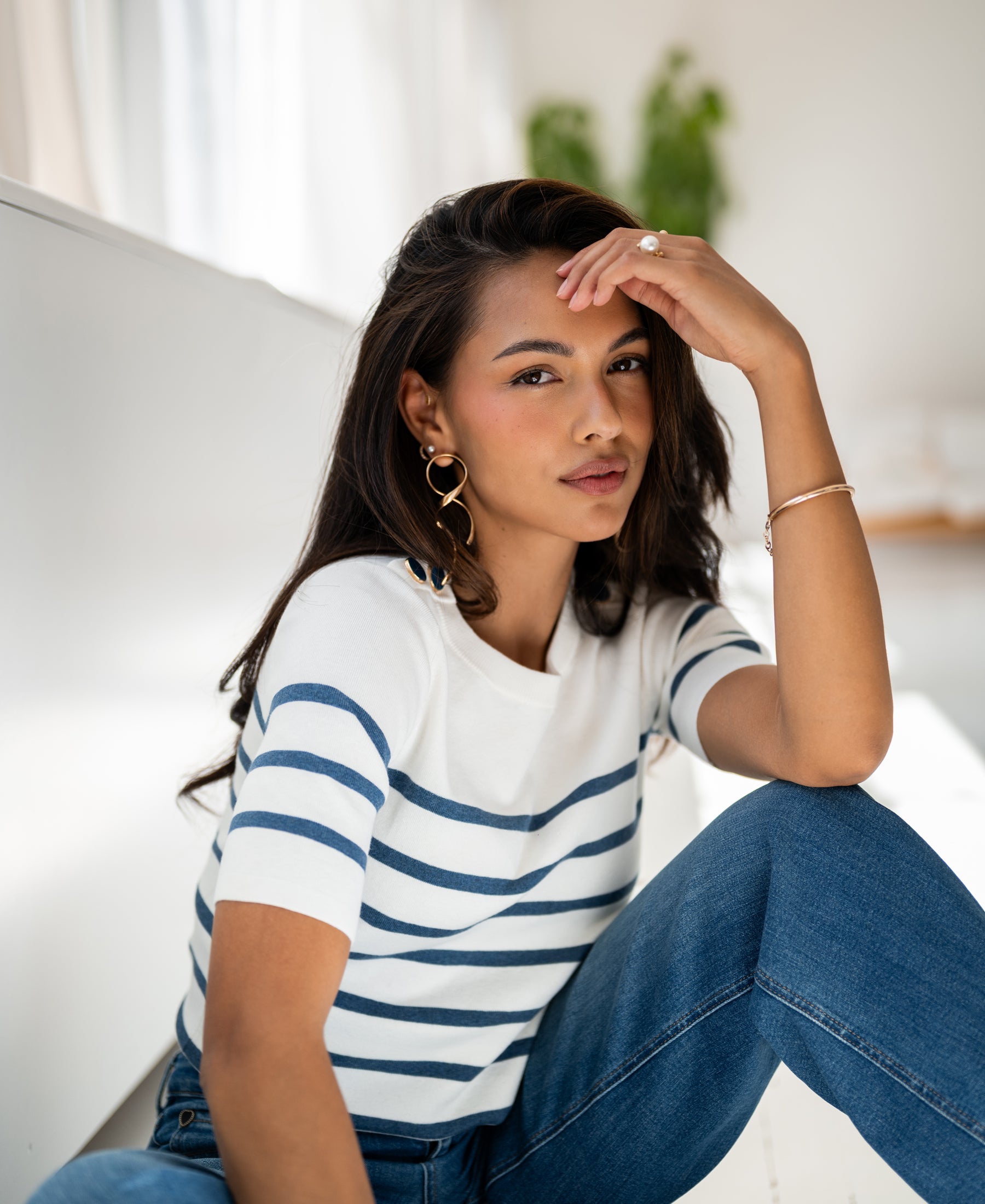 Breton sweater in ivory and denim blue by Plein Publique, shown indoors.