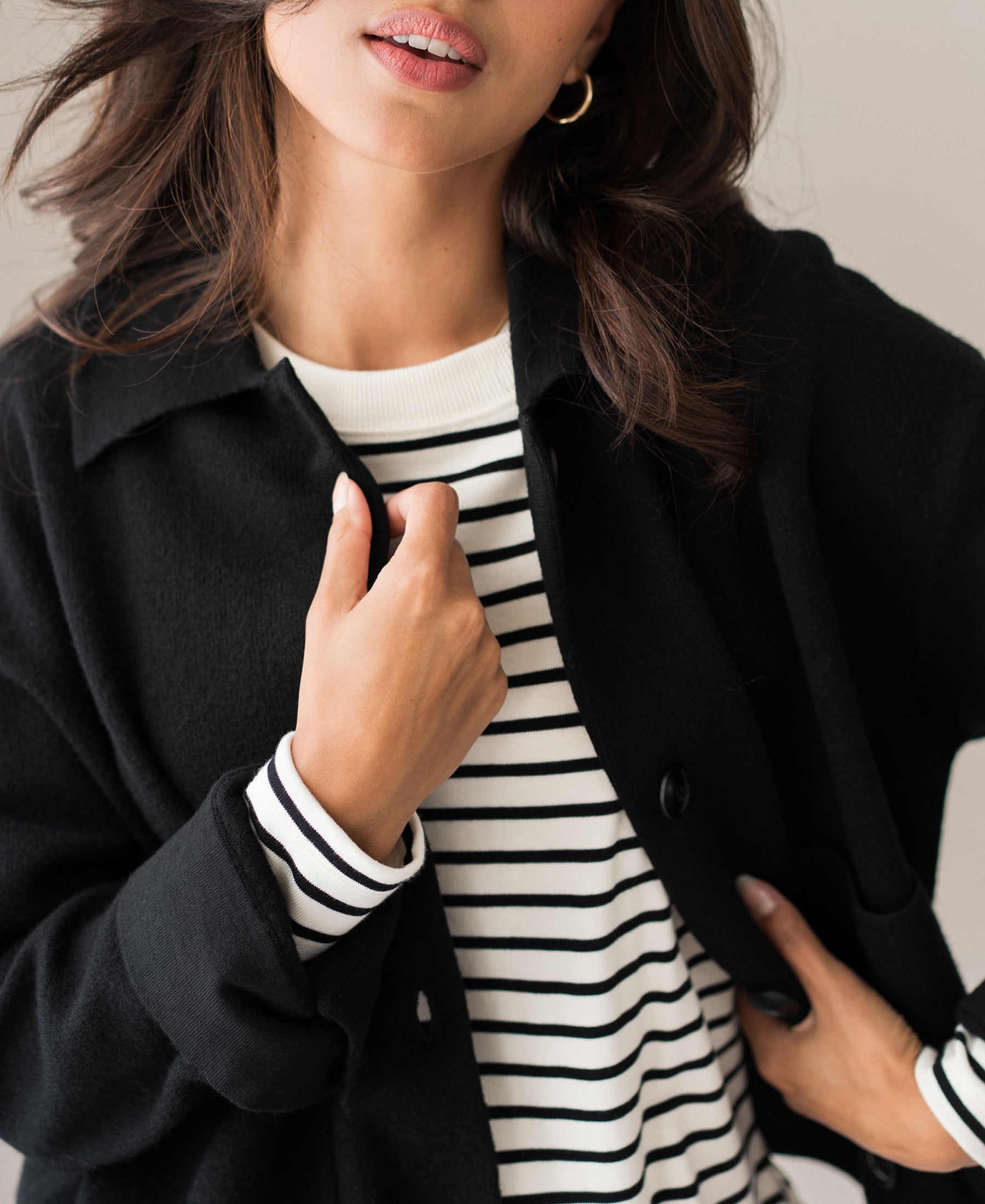 Woman wearing black wool LA FAYE jacket, holding the lapel.