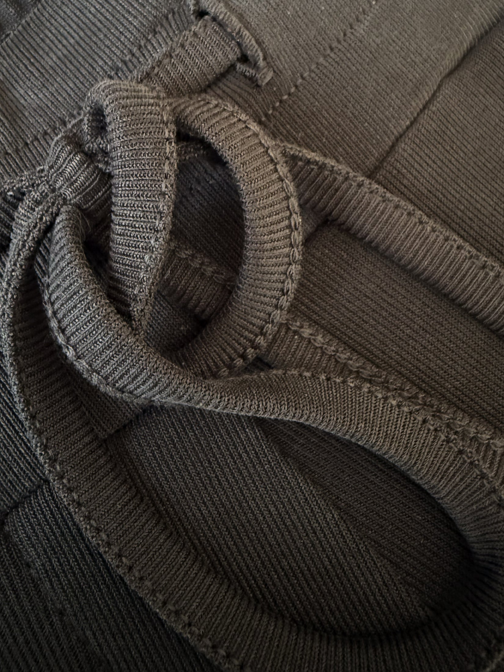 Close-up of charcoal lounge pants with drawstring bow and silky viscose jersey fabric.