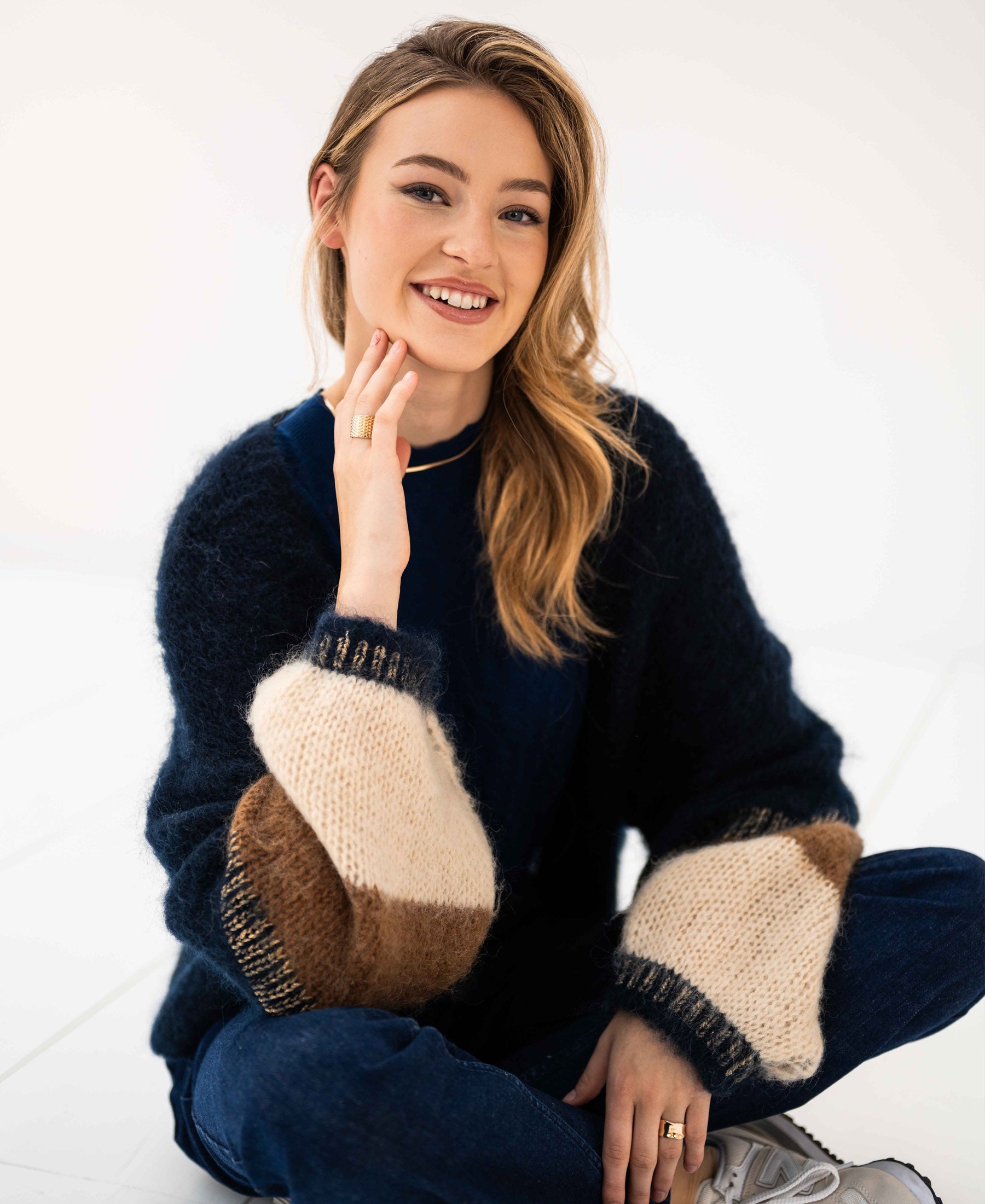 Dark blue fluffy vest in a textured material, shown worn by a woman.