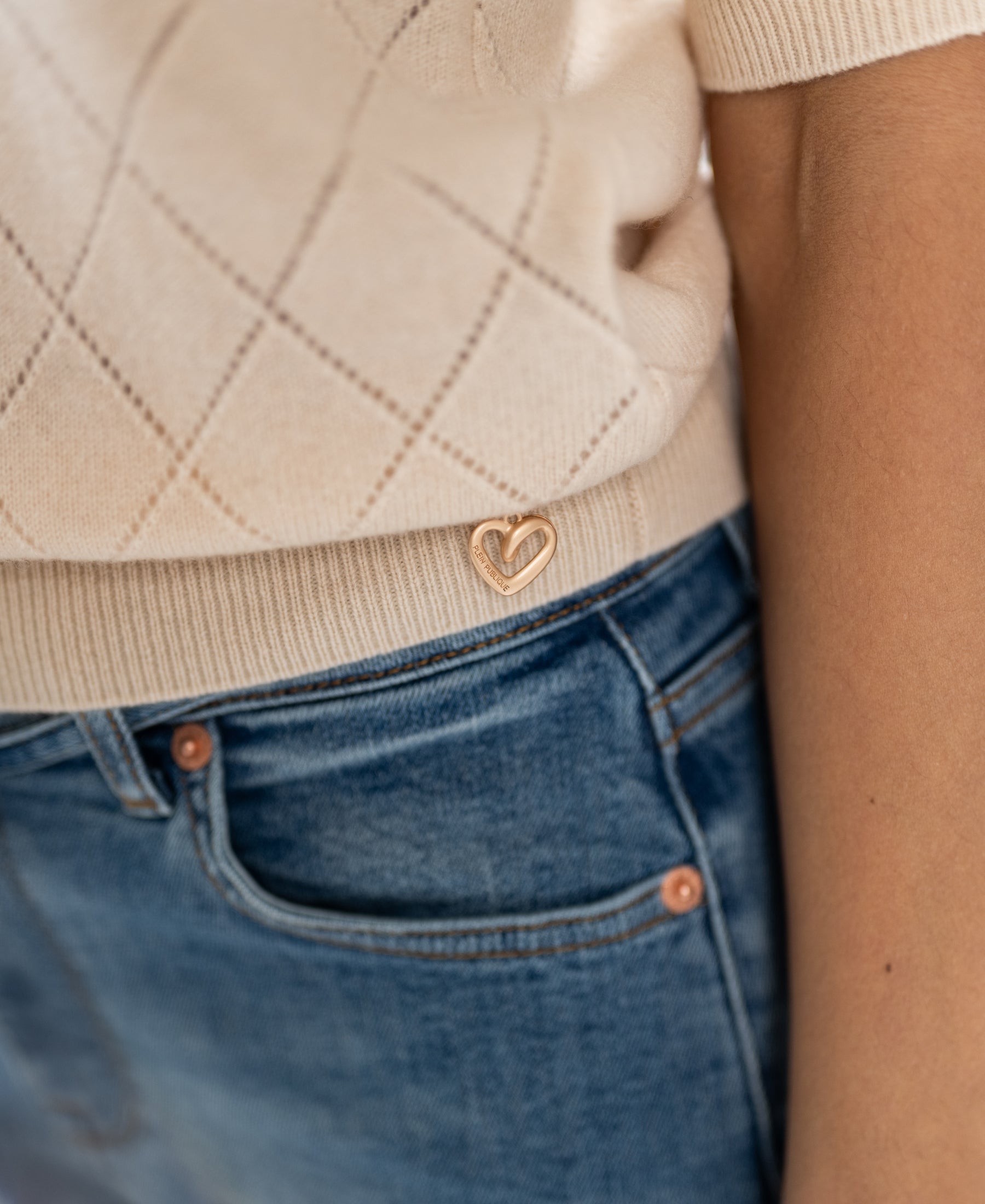 A close-up of the PLEIN PUBLIQUE Argyle merino wool LE HARVARD Butter sweater.