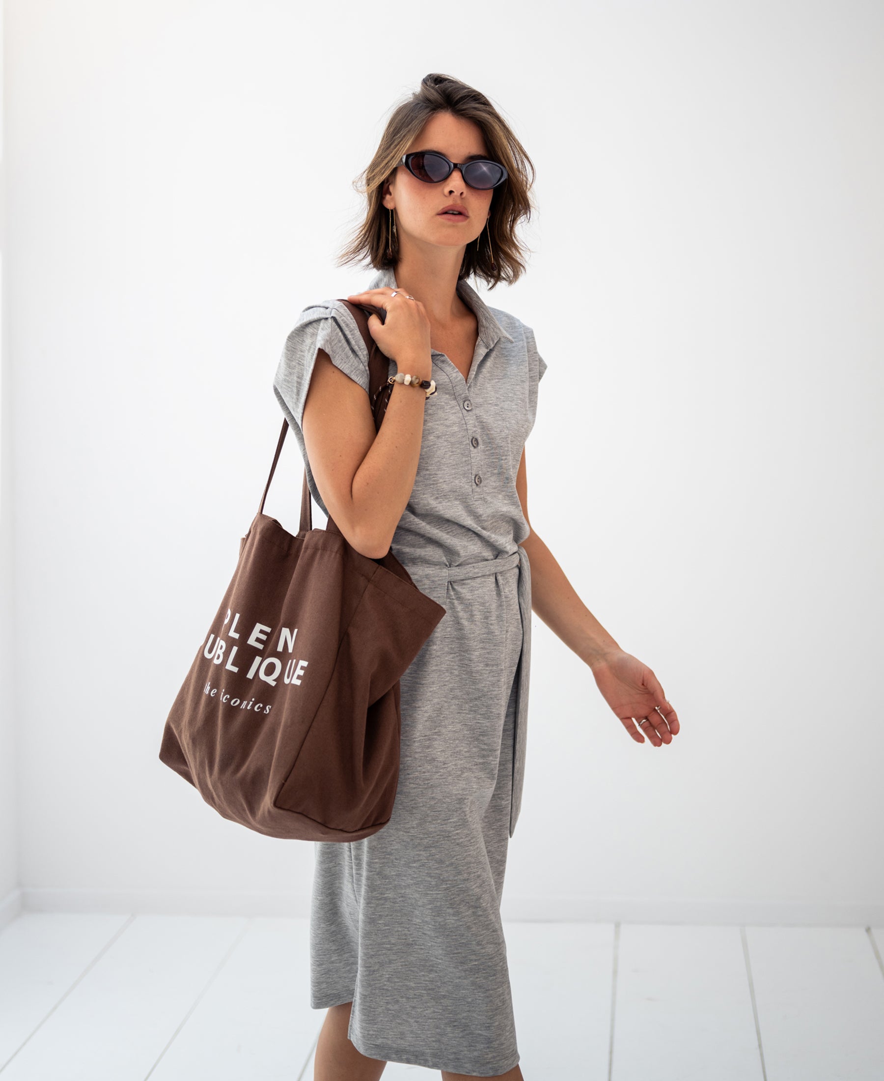 Woman wearing a grey melange INES Travel polo dress by PLEIN PUBLIQUE.