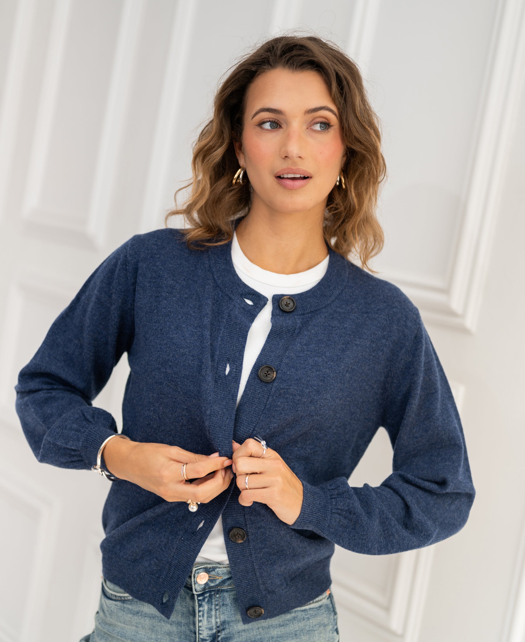Indigo blue vest with a relaxed fit, buttoned up to show design and style.