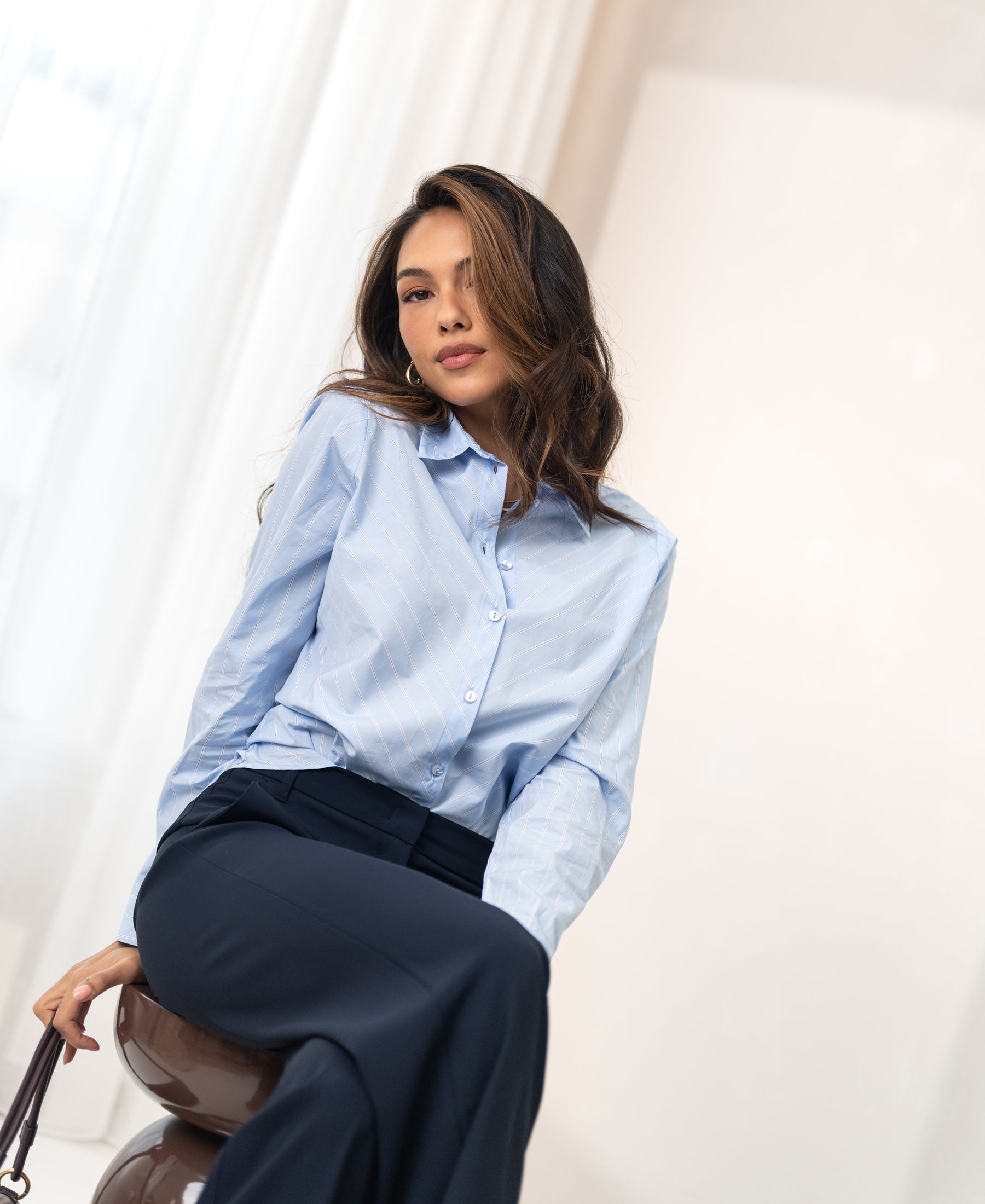 Light blue, white, and navy striped blouse from PLEIN PUBLIQUE LA LOIRE displayed on a woman.