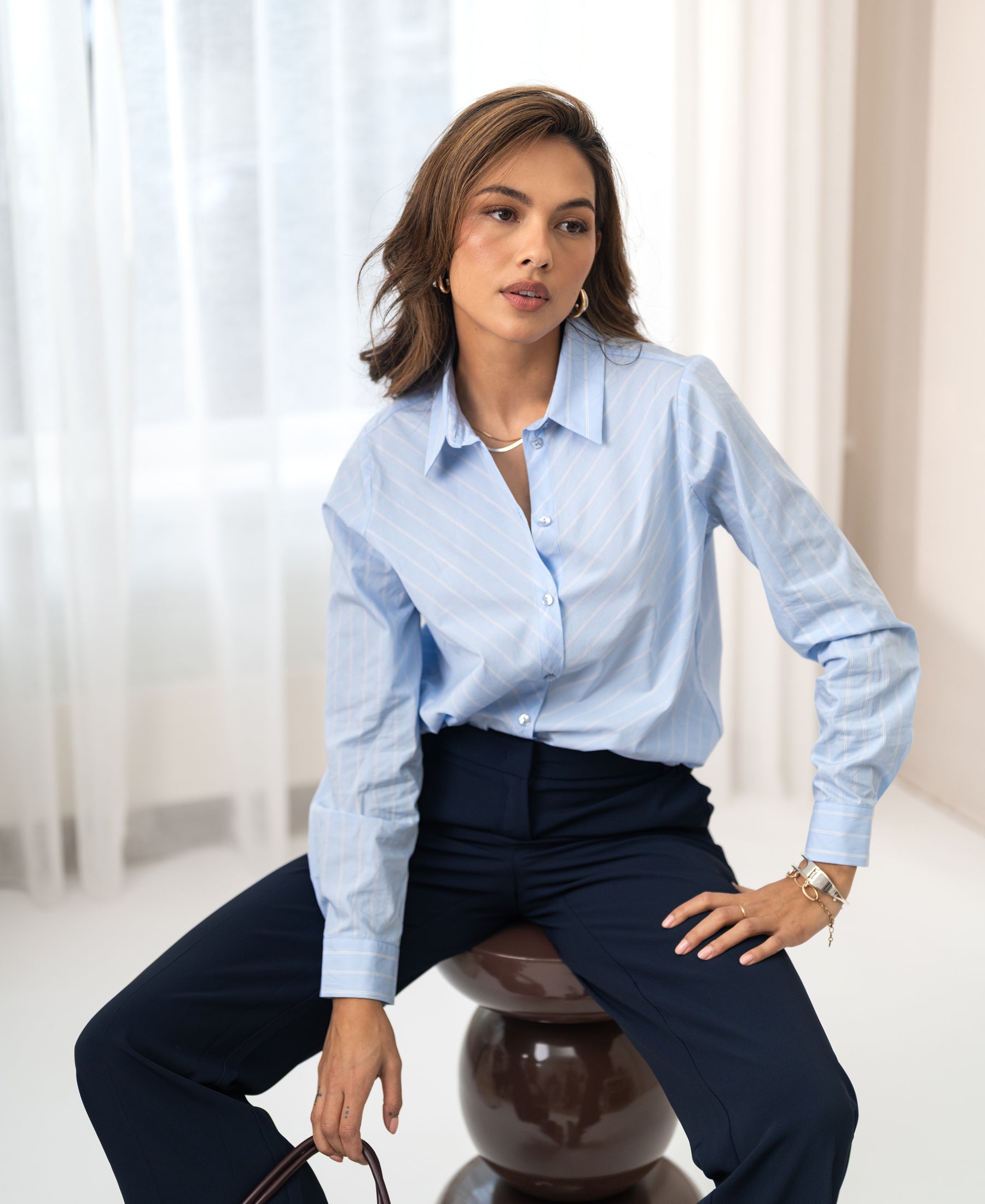 The Plein Publique striped blouse La Loire in light blue, white, and navy.