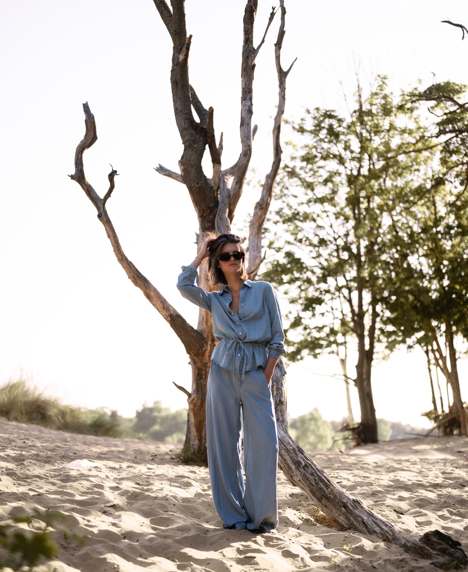 Bleached Tencel jeans in a classic cut, shown in an outdoor setting.