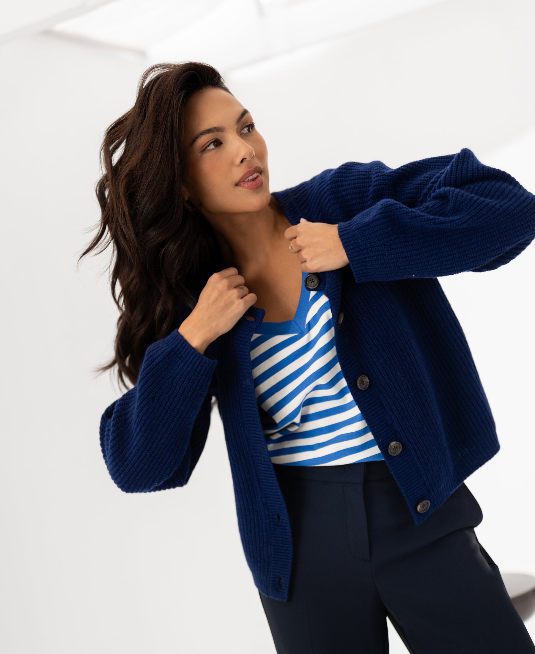 Navy merino wool vest by PLEIN PUBLIQUE, shown on model against a white background.