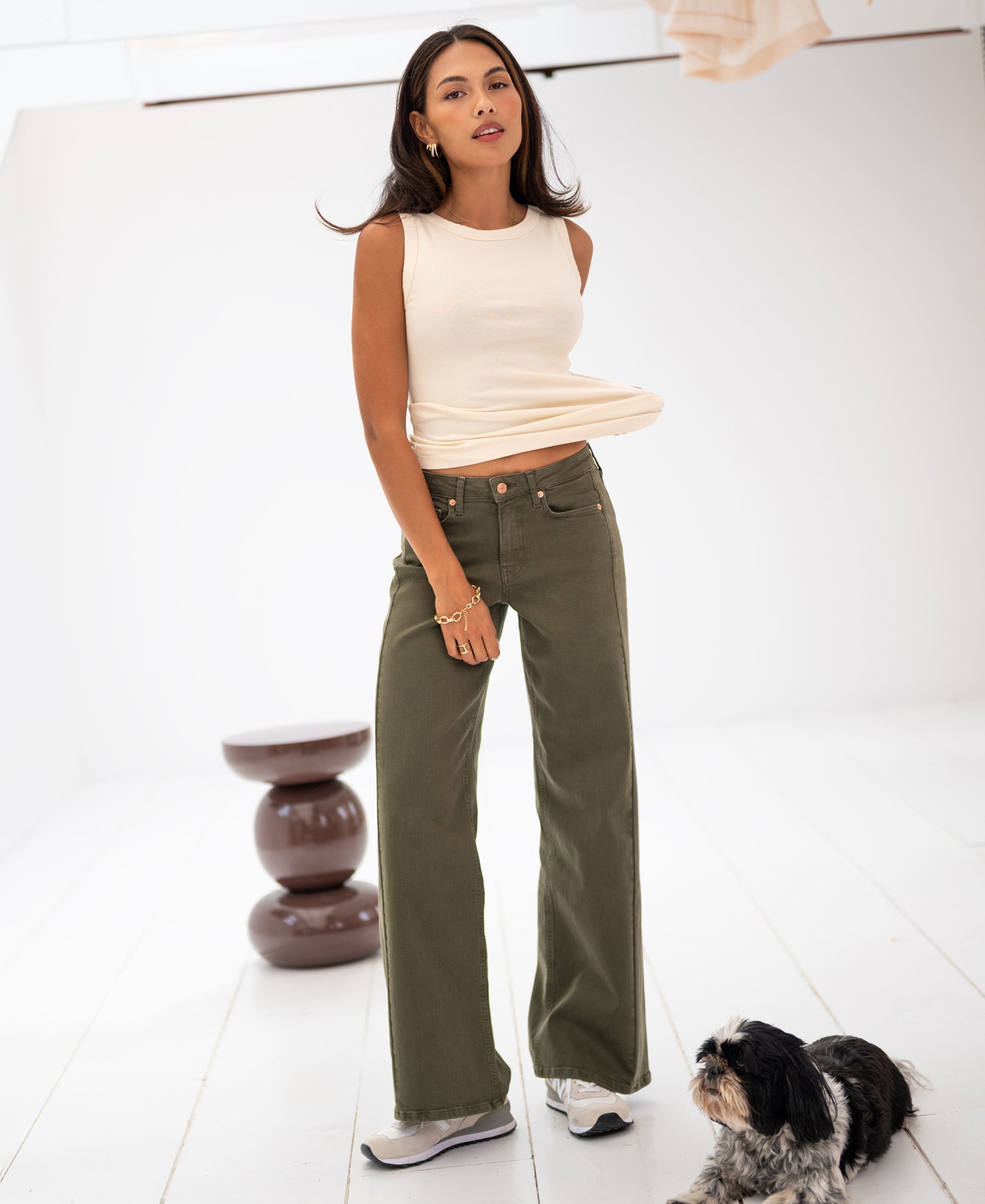 Wide leg jeans in army green by LE SPICE, shown indoors.
