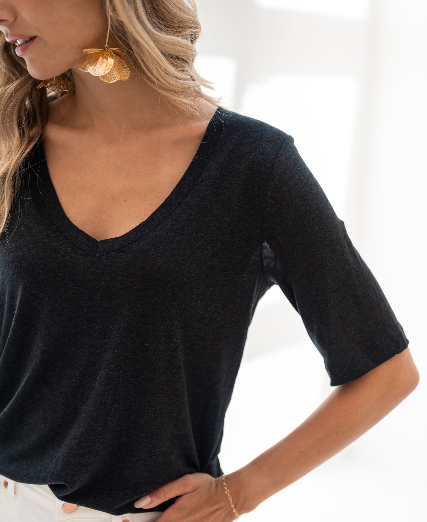 Black linen T-shirt in bright natural light.