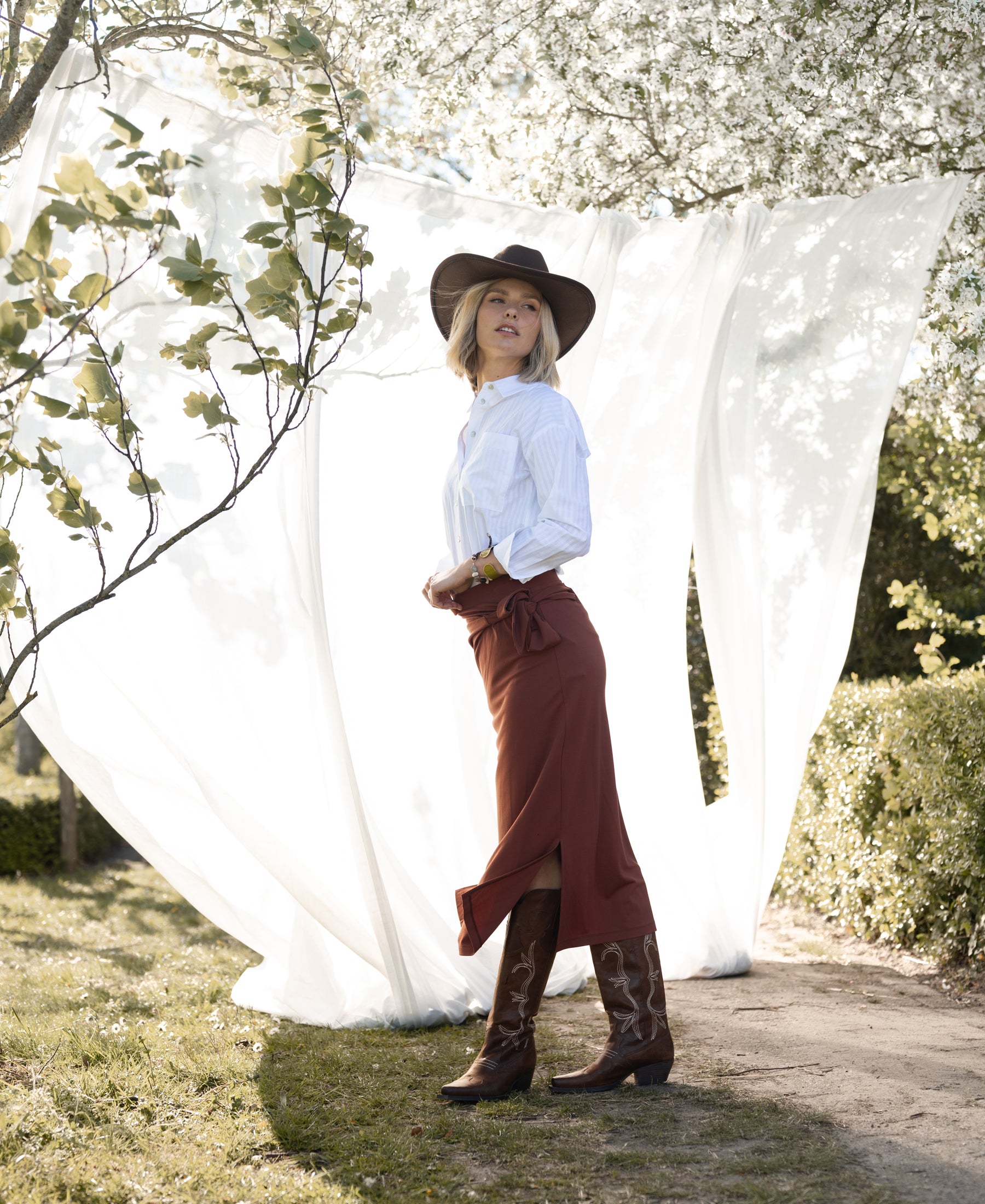 White striped LA PASCALLE blouse by PLEIN PUBLIQUE, shown outdoors.