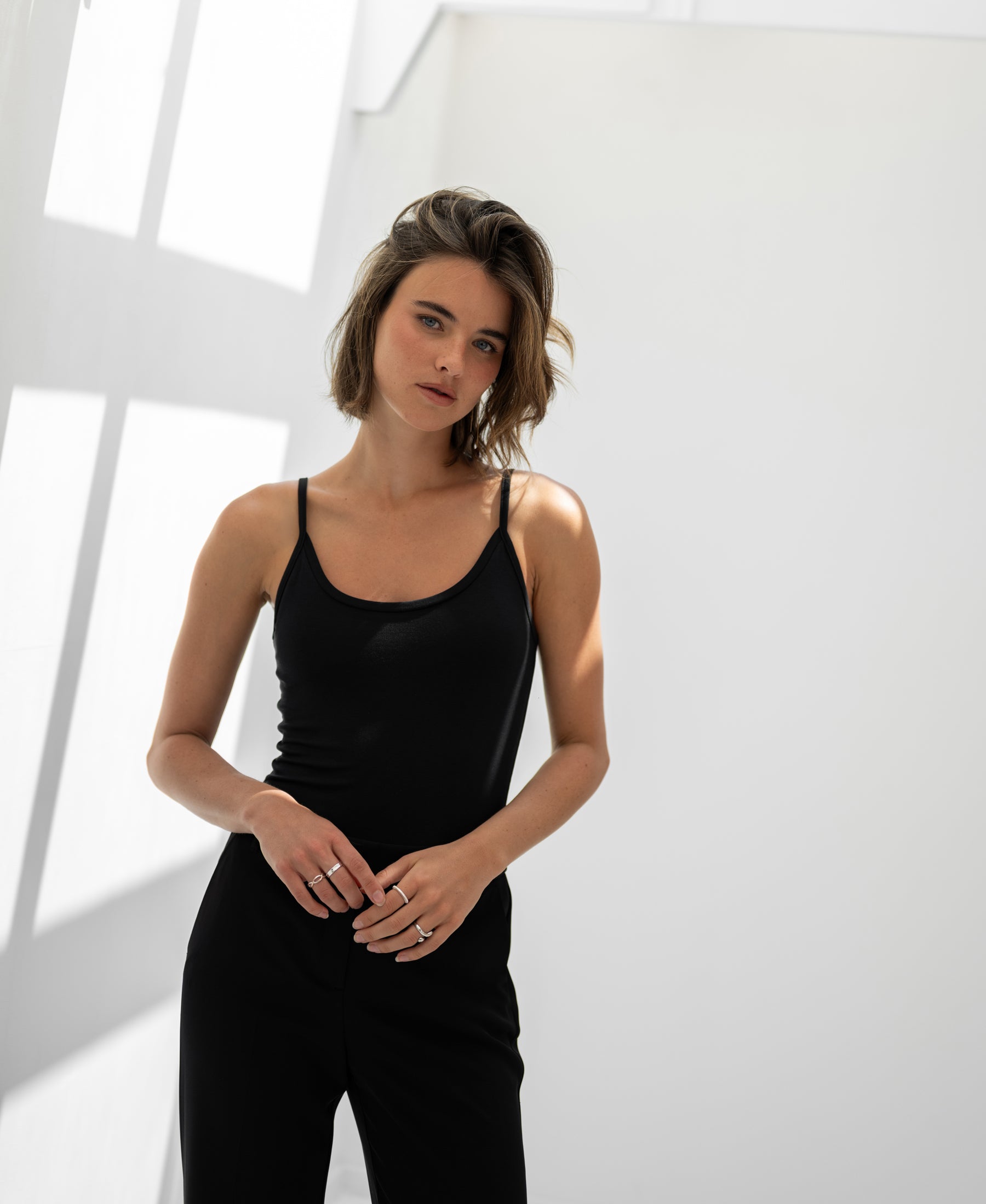 Black Second Skin Top LE MARAIS by PLEIN PUBLIQUE shown in a bright, minimalist room.