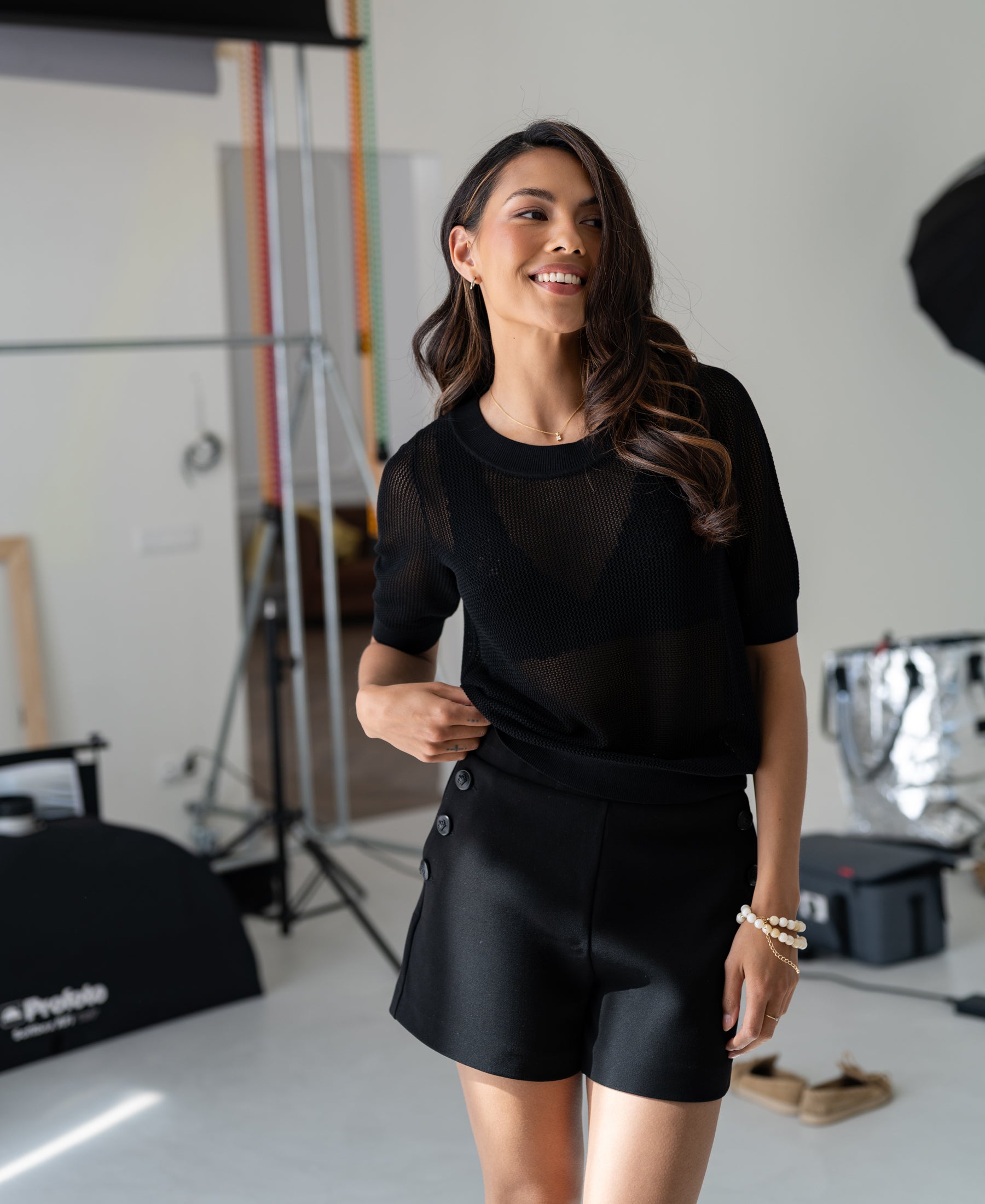 Black LA LILLY buttoned shorts by PLEIN PUBLIQUE shown in a bright studio.