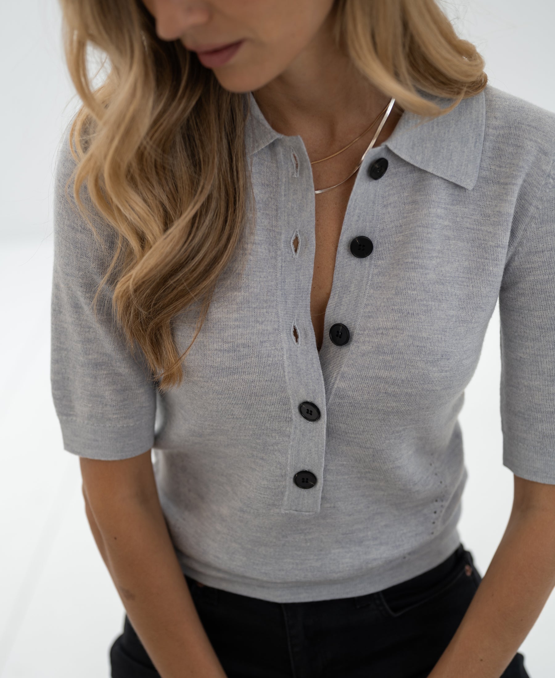 Light gray merino wool polo shirt in a classic style, shown from the front.