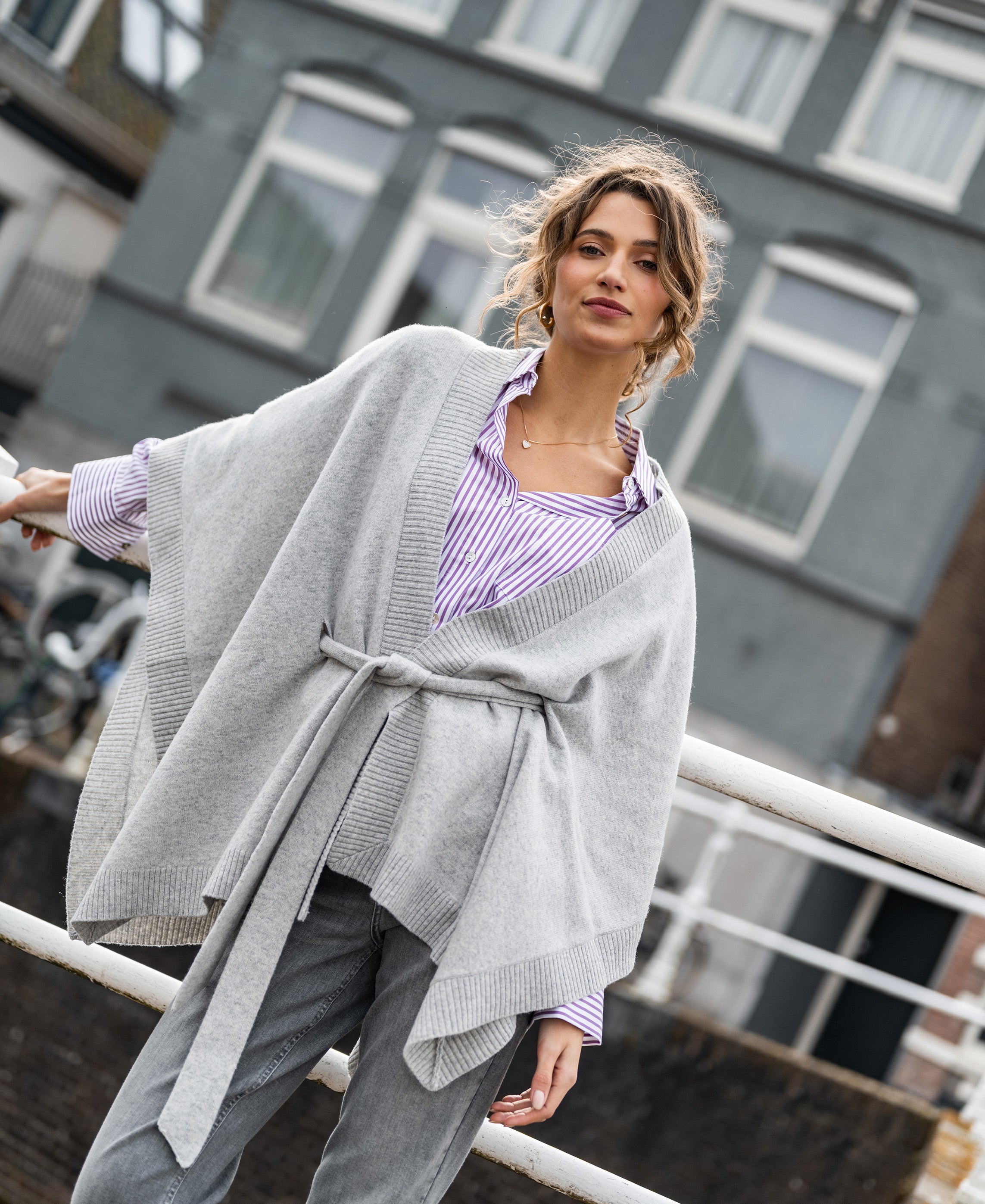 Light grey merino wool poncho cardigan, shown outdoors.