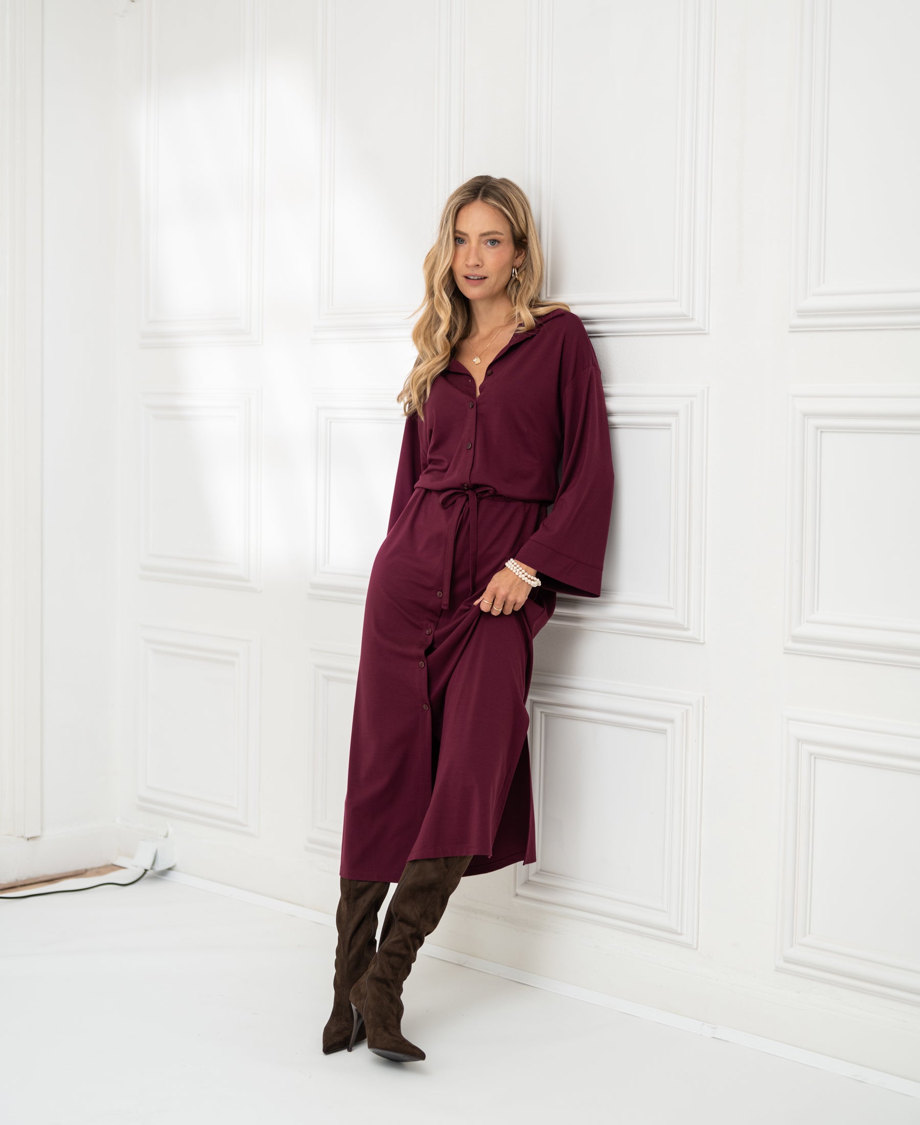 Woman wears the PLEIN PUBLIQUE button-down dress LE RAPHAEL in Bordeaux red.