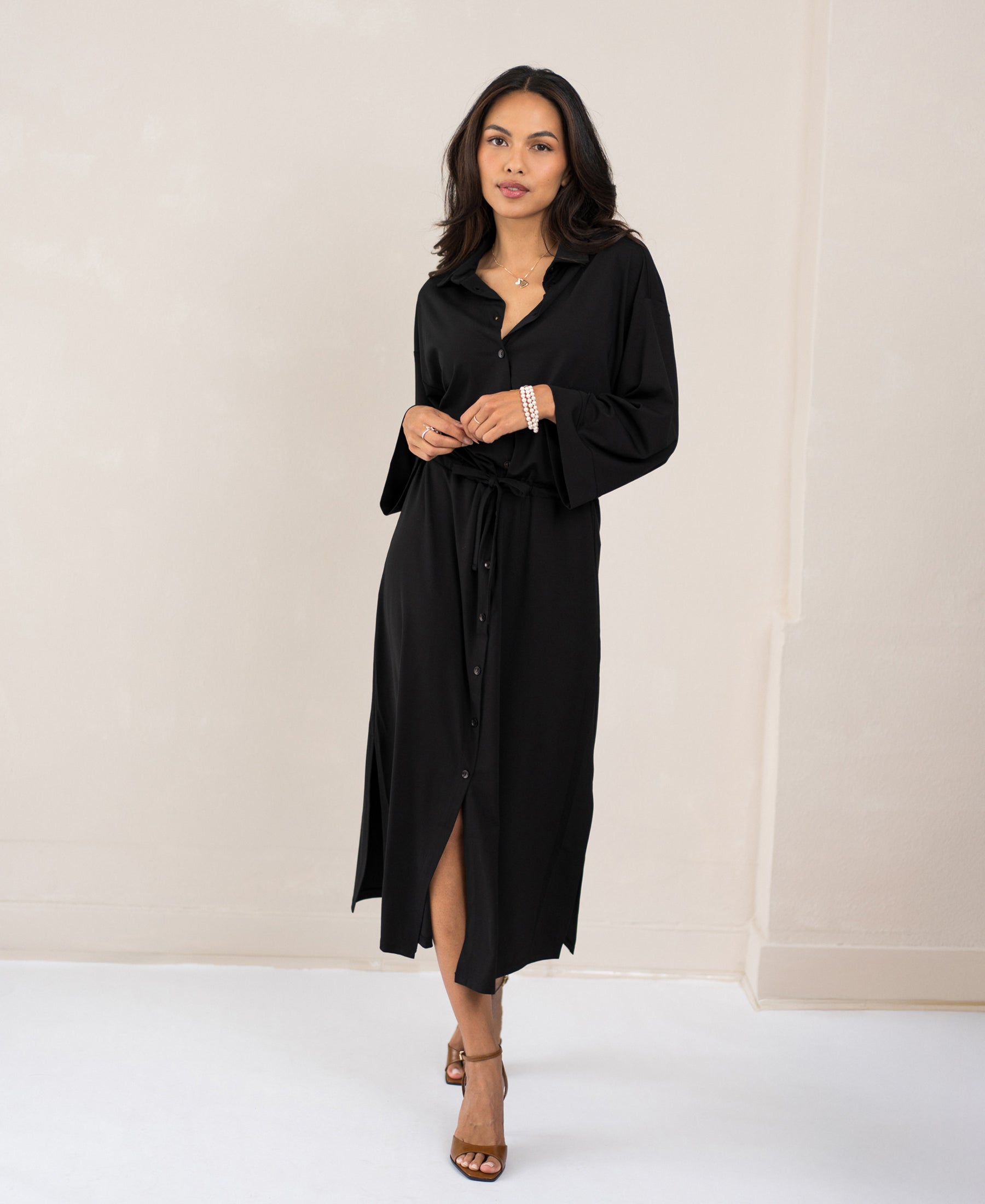 Black button-down dress LE RAPHAEL by PLEIN PUBLIQUE, shown on model standing against a light wall, front view.