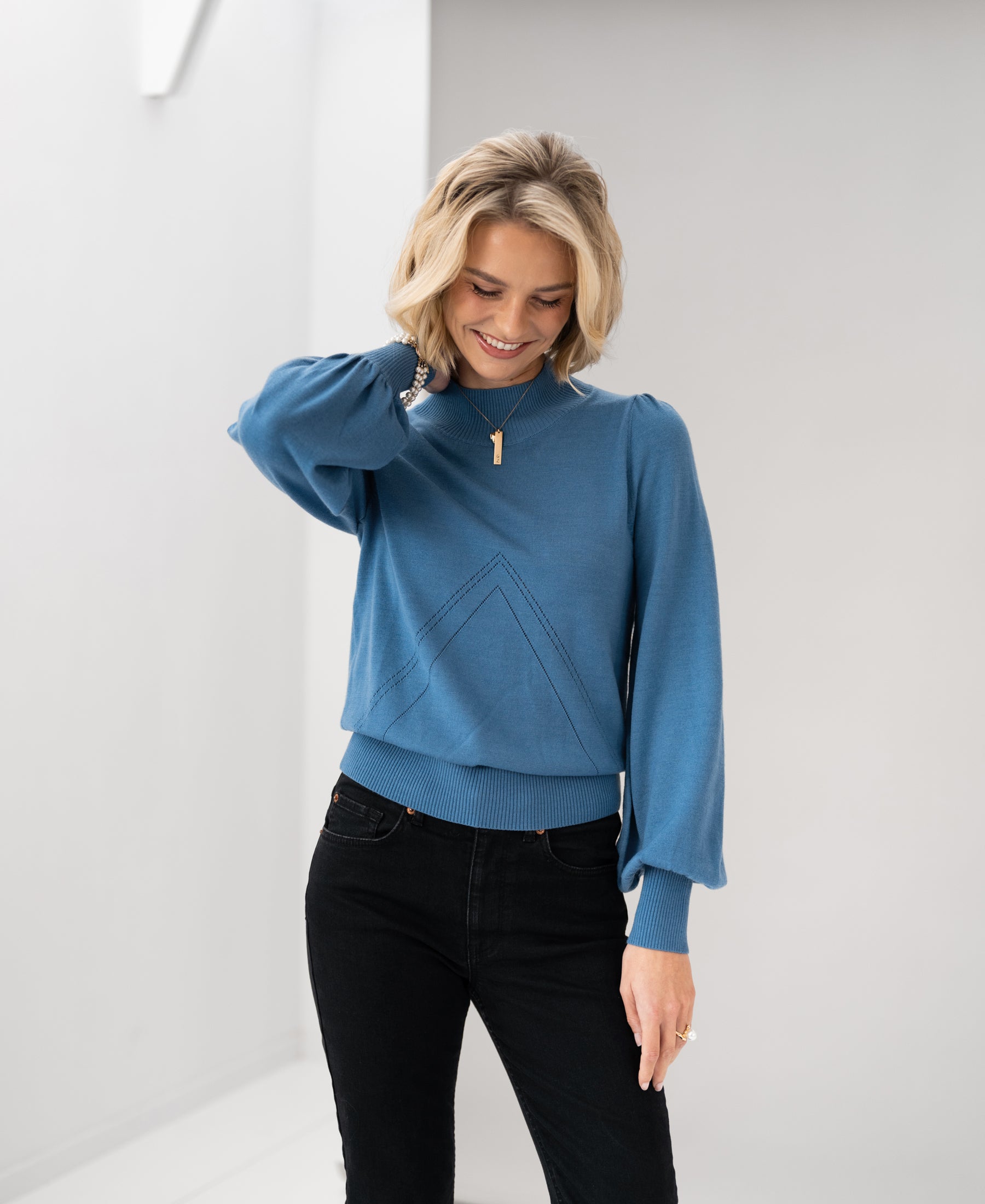 Steel blue turtleneck sweater in PLEIN PUBLIQUE LES SALLES style, shown indoors.