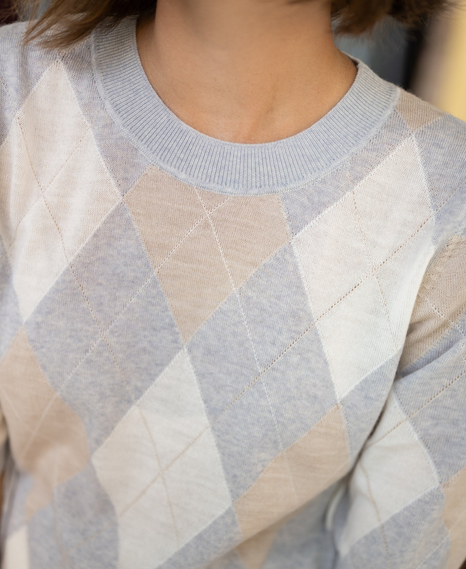 Light grey melange argyle merino wool sweater, shown from shoulders to neck.