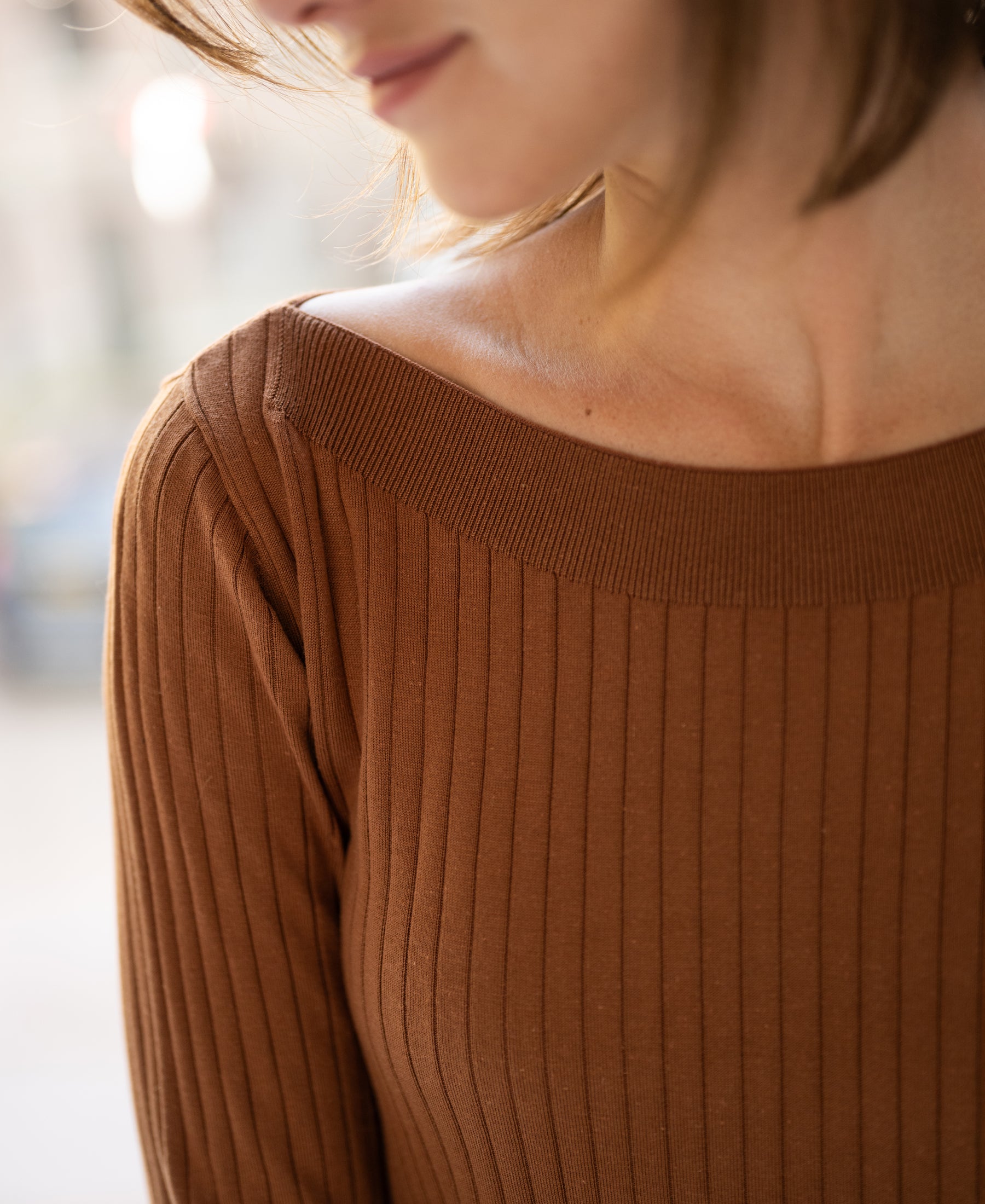 Tencel-silk boat neck sweater LA TULIPE in Havana color, shoulders up, face partially out of frame.