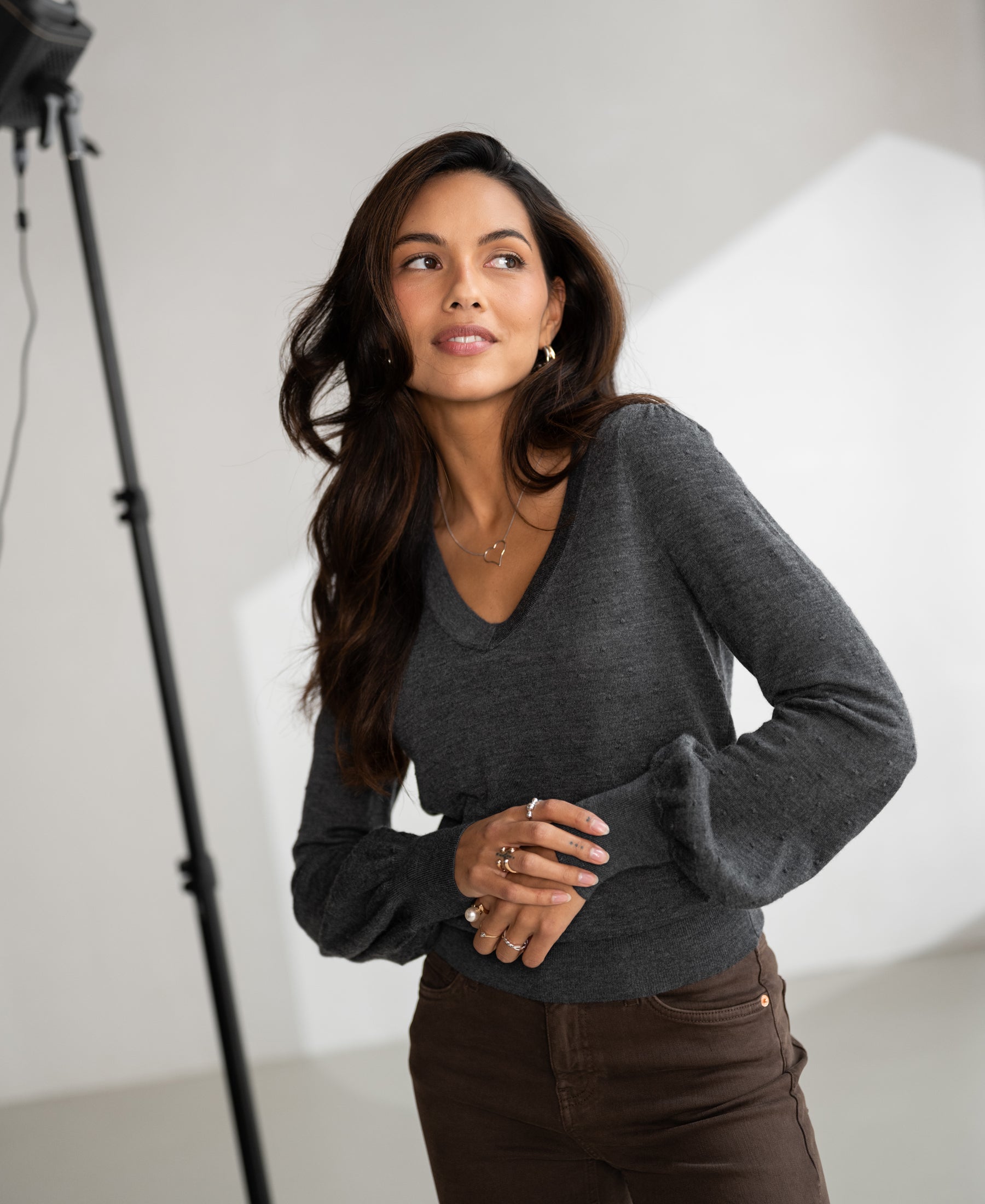 Merino wool V-neck sweater LA VICTORIA by PLEIN PUBLIQUE, shown indoors.