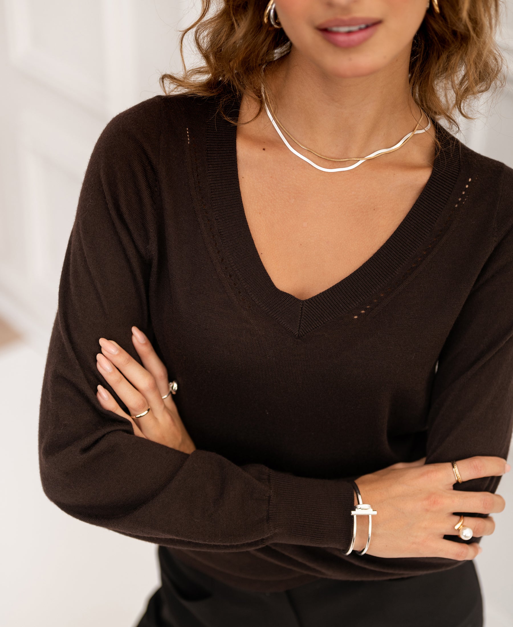 Woman wearing PLEIN PUBLIQUE Merino V-neck sweater LA VILLE in pure choco color.