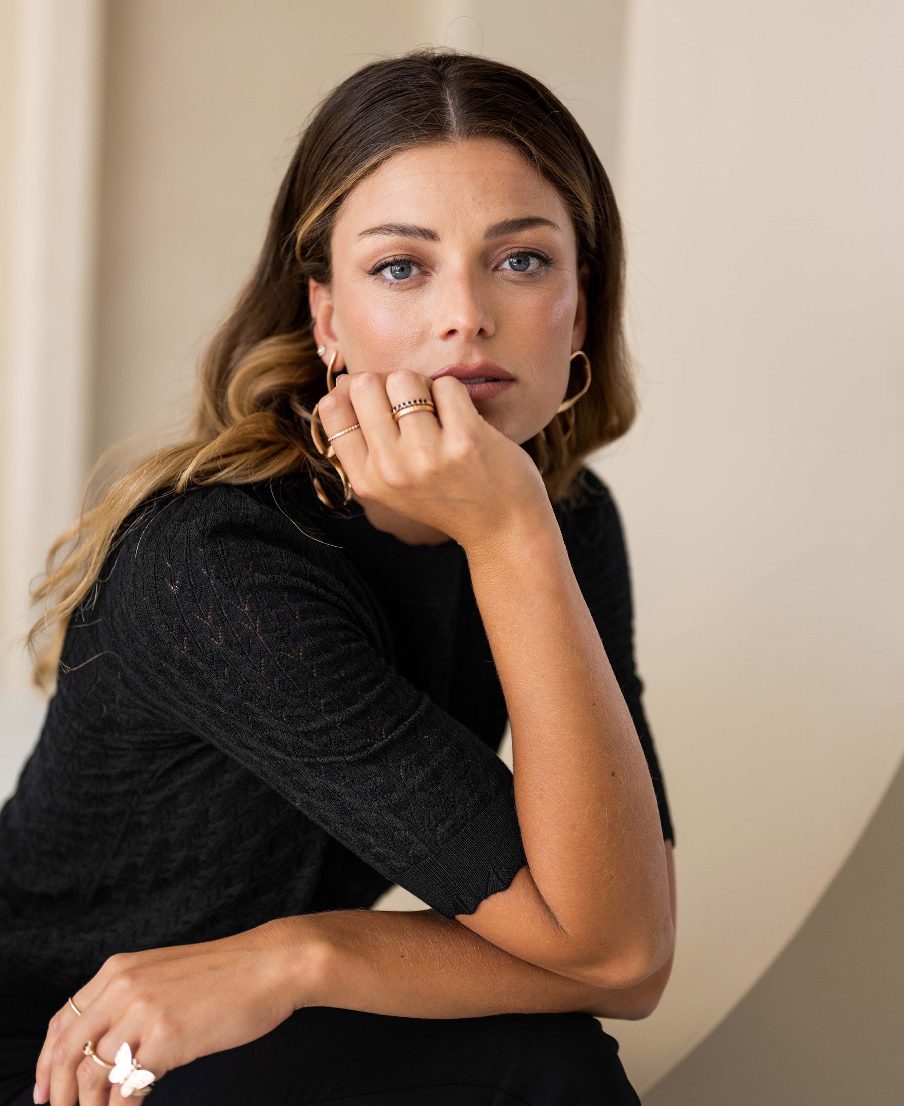 Black merino wool sweater with a wavy knit pattern, shown from the front.