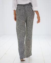 Charcoal-Ivory Stippenbroek LES ANDELYS pants shown from behind in a white room.