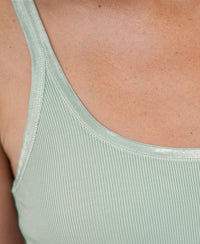 Close-up of the Luxe Cami top in light mist green, showing the strap and upper chest.