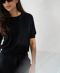 Black sweater with heart pattern by PLEIN PUBLIQUE.