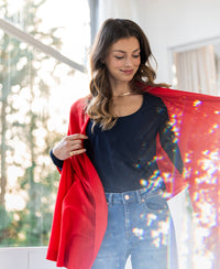 Woman near a sunlit window wears a dark blue bamboo t-shirt.