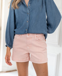 Blush garment-dyed stretch twill shorts in a style called LA BILLY, shown indoors.