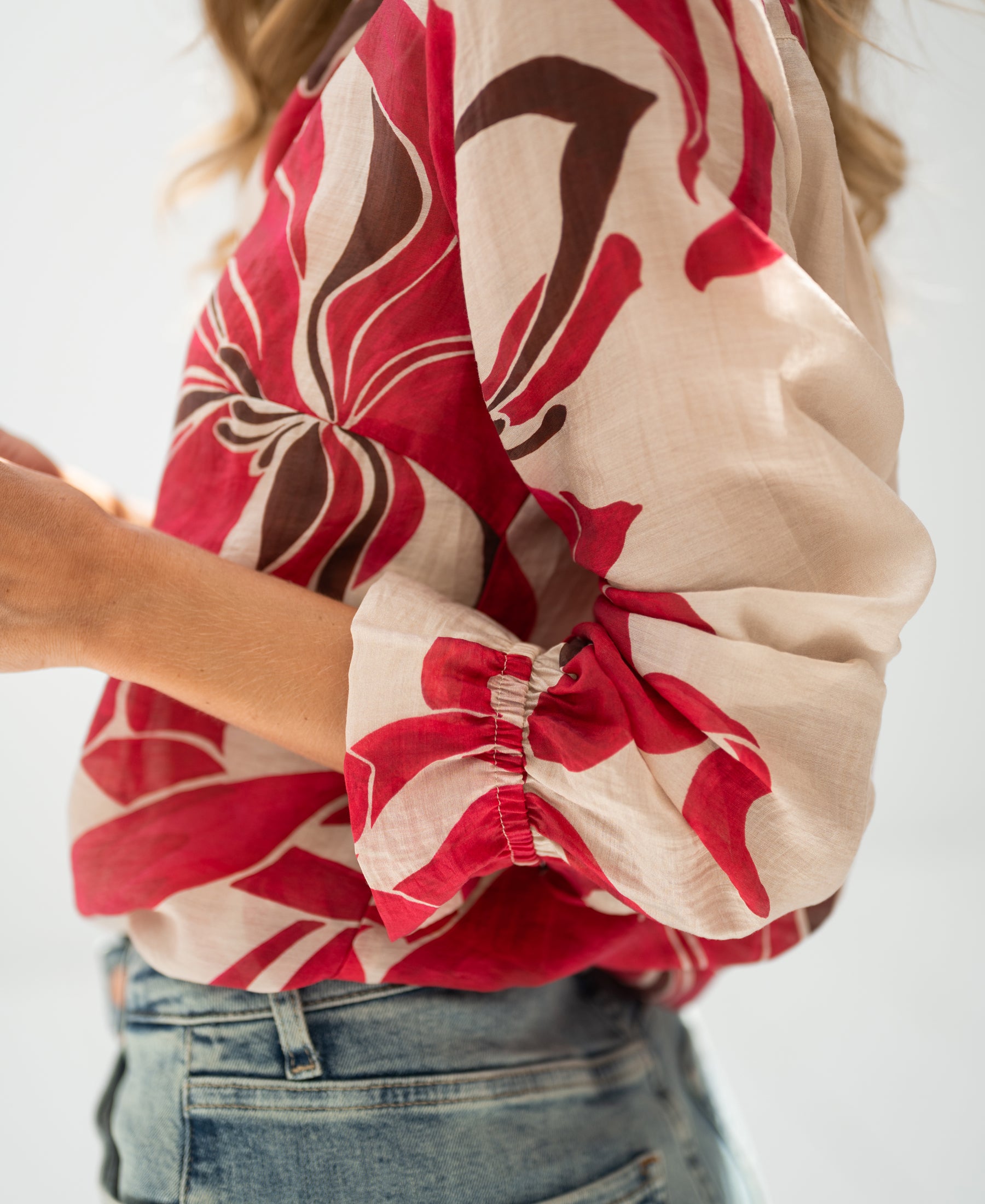 Ruby Red print blouse, side view, cropped at shoulder.