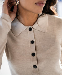 Beige merino wool polo shirt in partial view. Only the product for sale is shown.