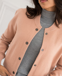 Antique blush bomber jacket LA BOMBA shown from shoulders down.
