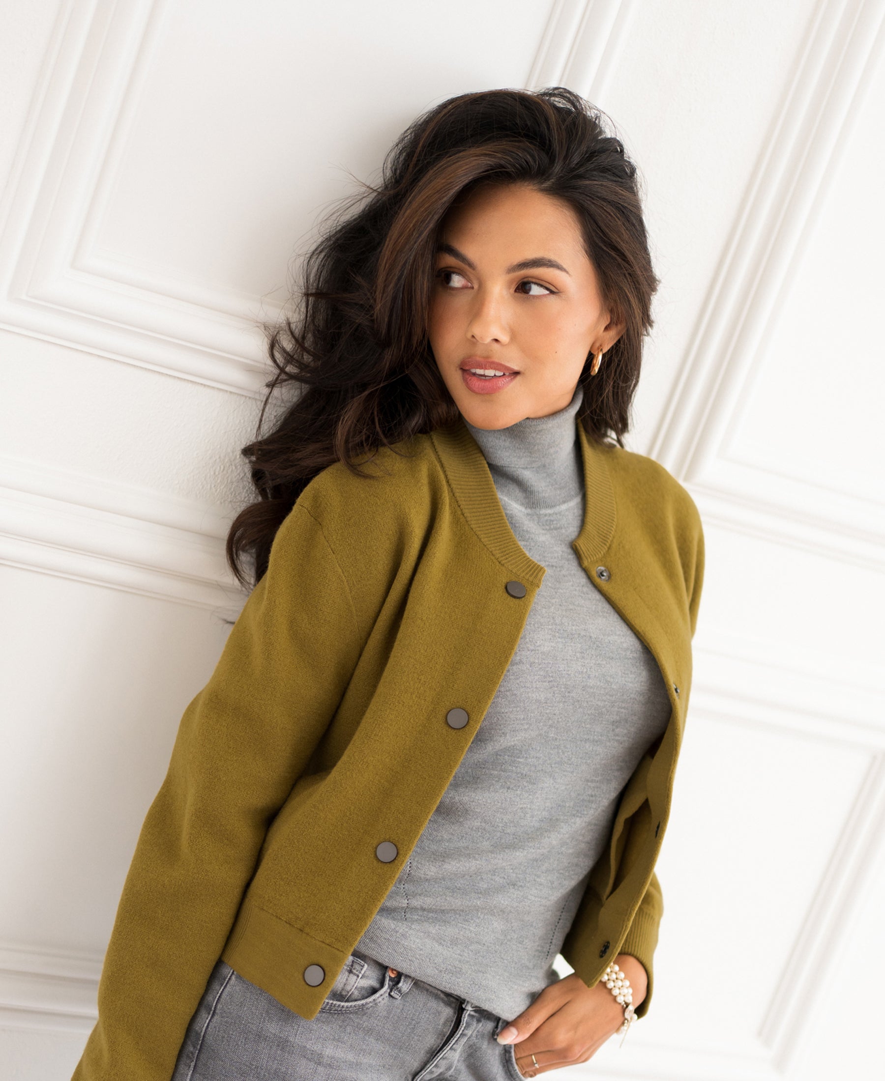 Olive green bomber jacket in a relaxed fit, shown from the front against a white wall.