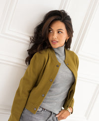 Olive green bomber jacket in a relaxed fit, shown from the front against a white wall.