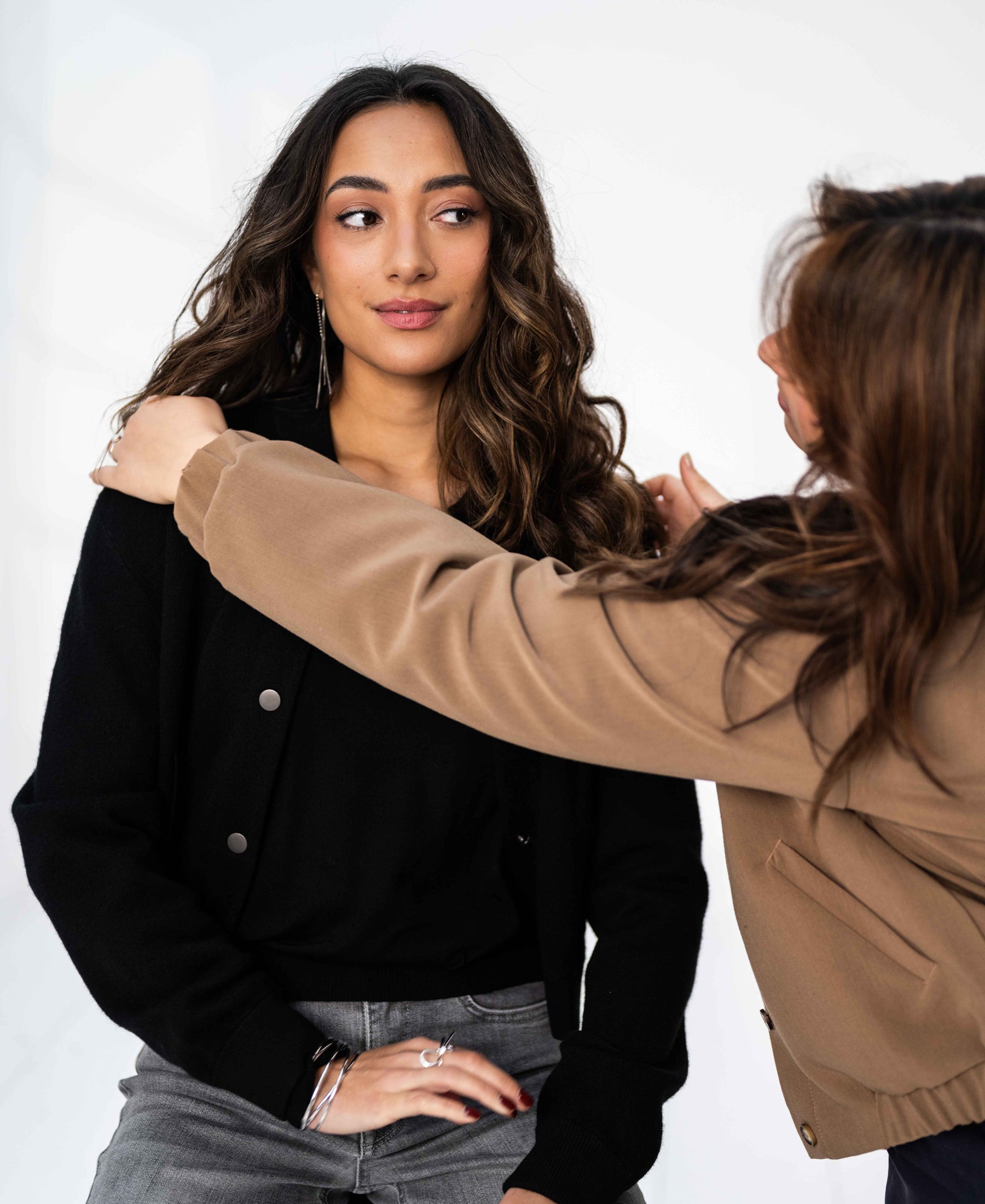Woman wearing a black PLEIN PUBLIQUE LA BOMBA bomber jacket, shown on a plain backdrop.