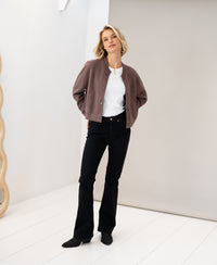 PLEIN PUBLIQUE bomber jacket in light-colored "Innuendo" shade, shown indoors.