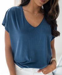 Woman wearing a ribbed blue T-shirt by PLEIN PUBLIQUE.